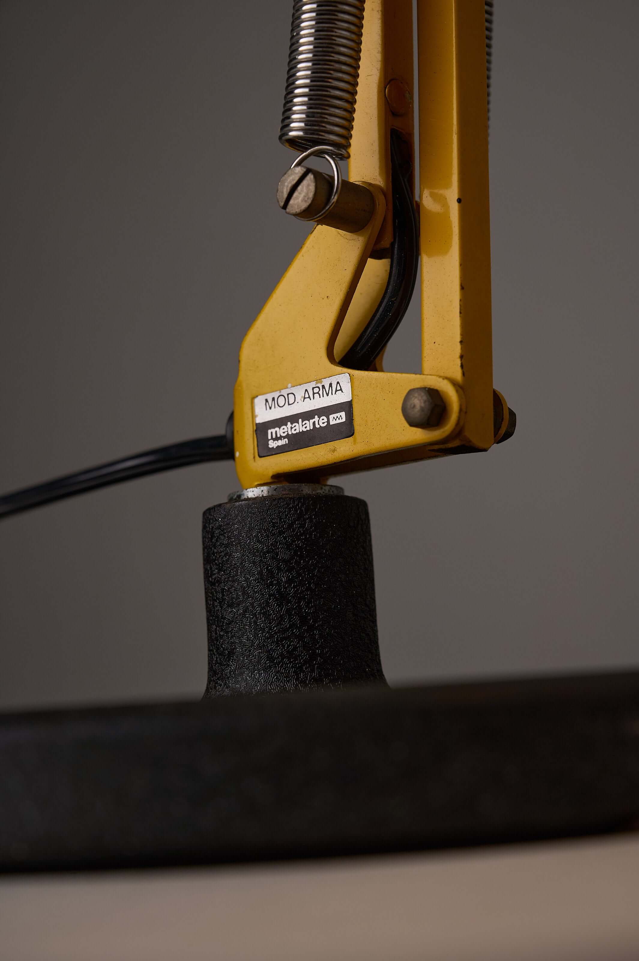 Close-up of the adjustable mechanism of the Yellow 'Arma' Desk Lamp by Metalarte, showcasing its design and craftsmanship.