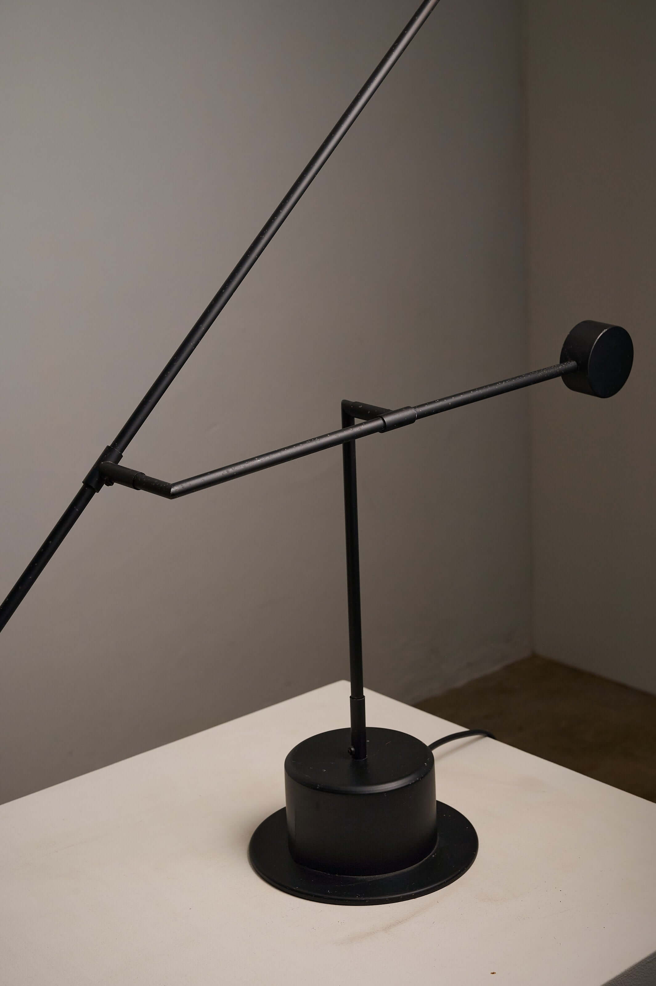 Matte Black Counterbalance Desk Lamp by Sische showcasing its minimalist design and smooth pivoting arm.