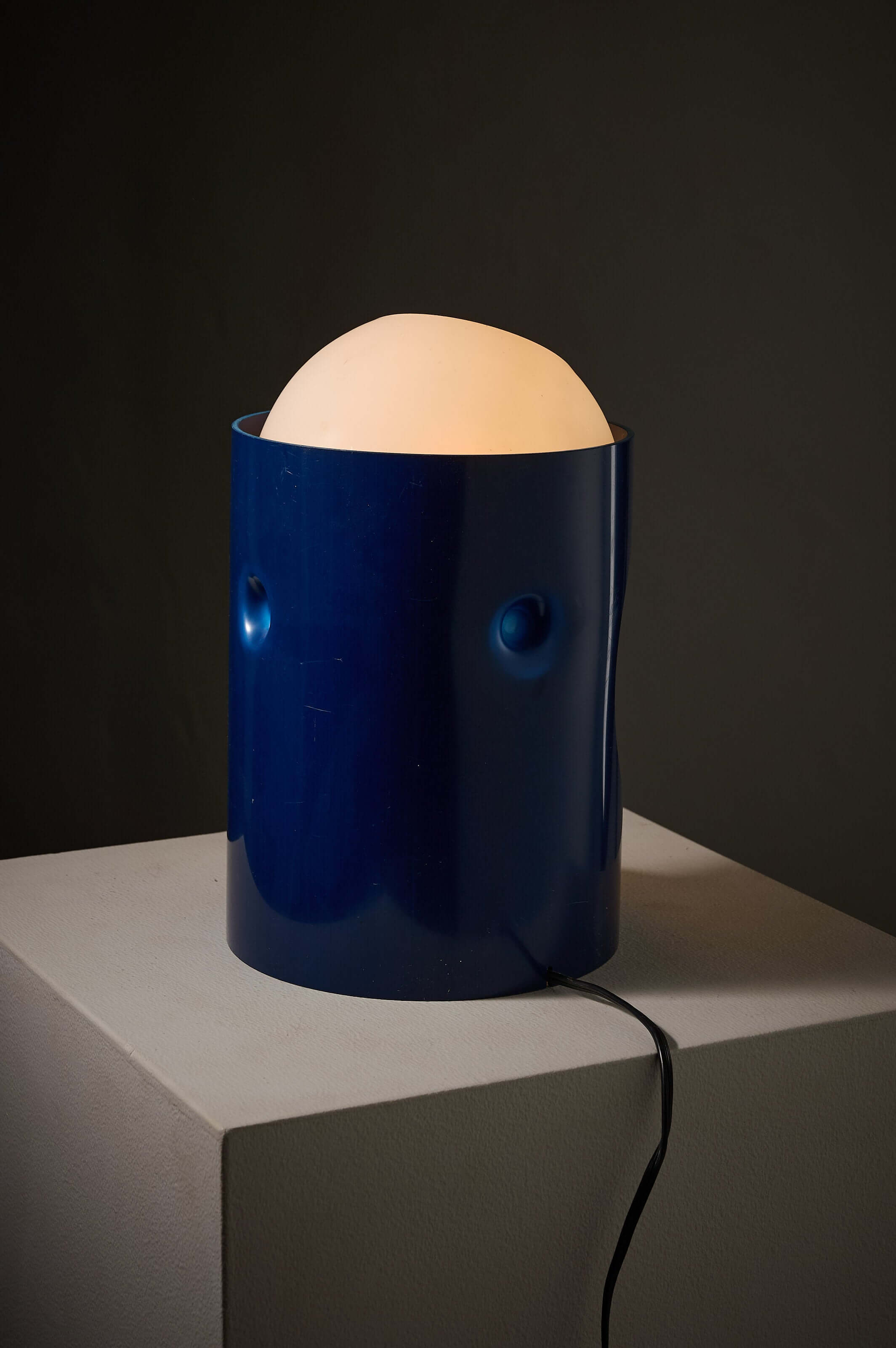 Blue 'L1' table lamp by Jacob Guggerli featuring a round glass sphere and vibrant blue plastic design.