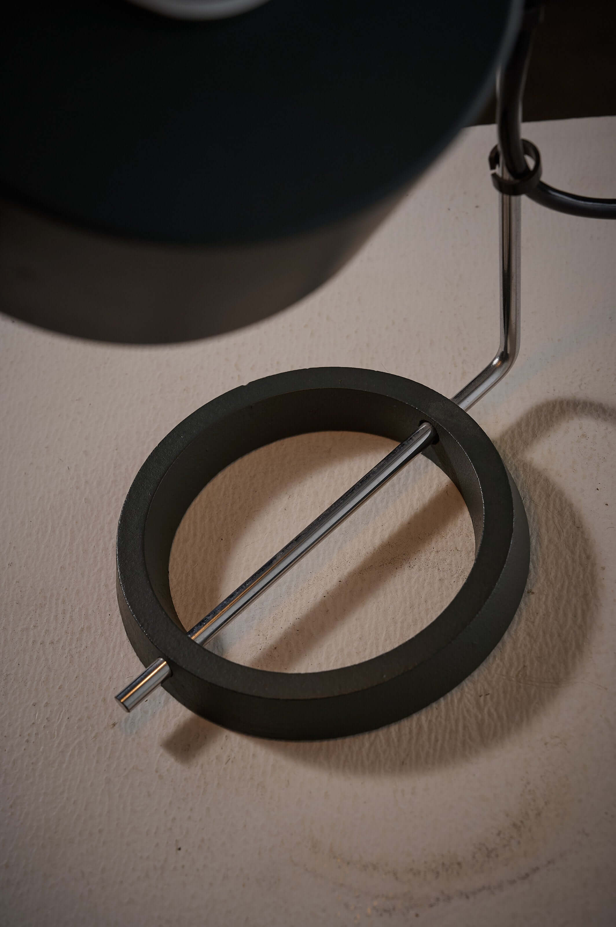 Close-up of the Minimalist Anthracite and Chrome Adjustable Desk Lamp with Ring Base showcasing the cast iron ring base.