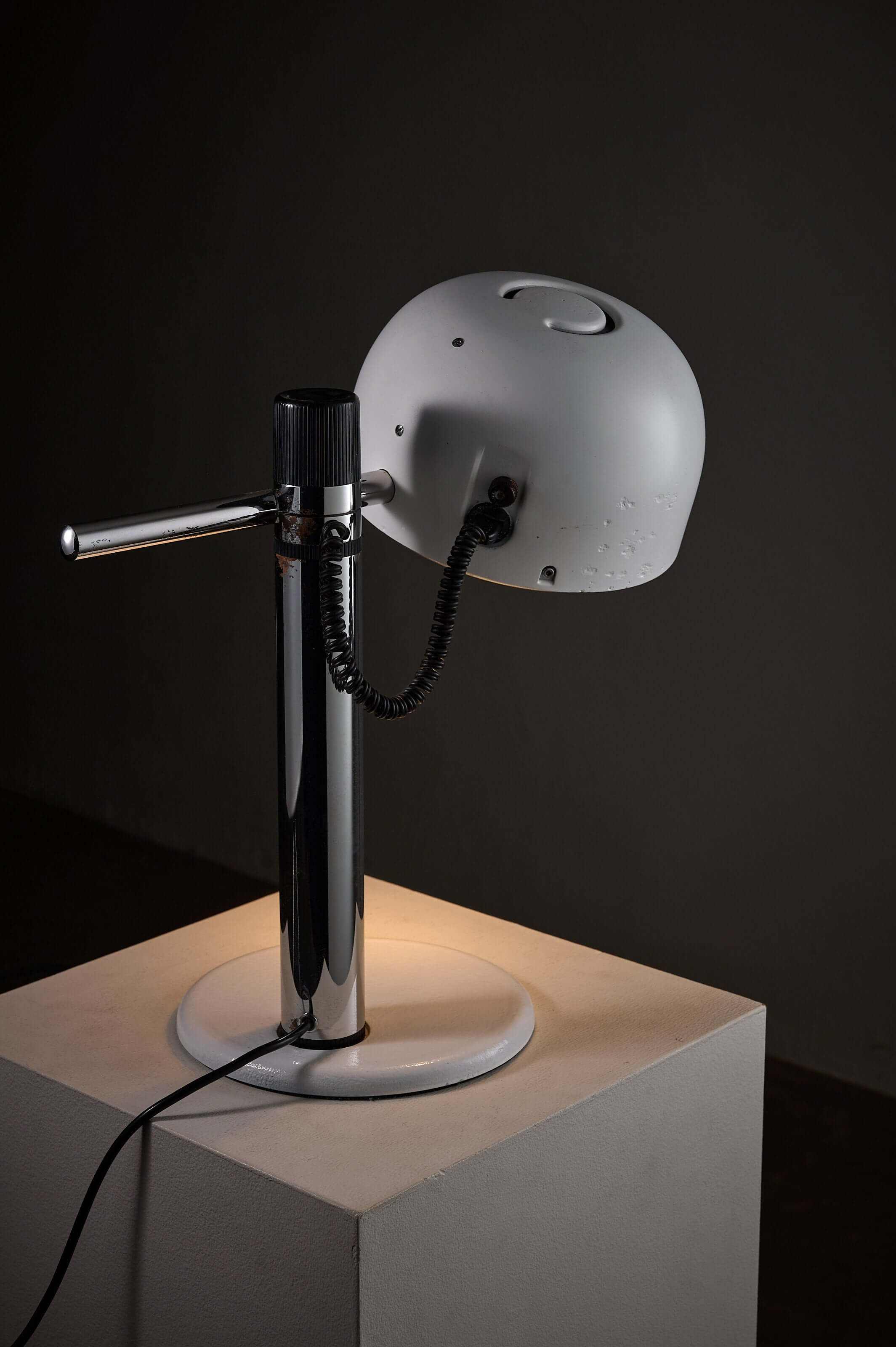 chrome table lamp Enrique Franch with white shade and adjustable arm on a modern base.