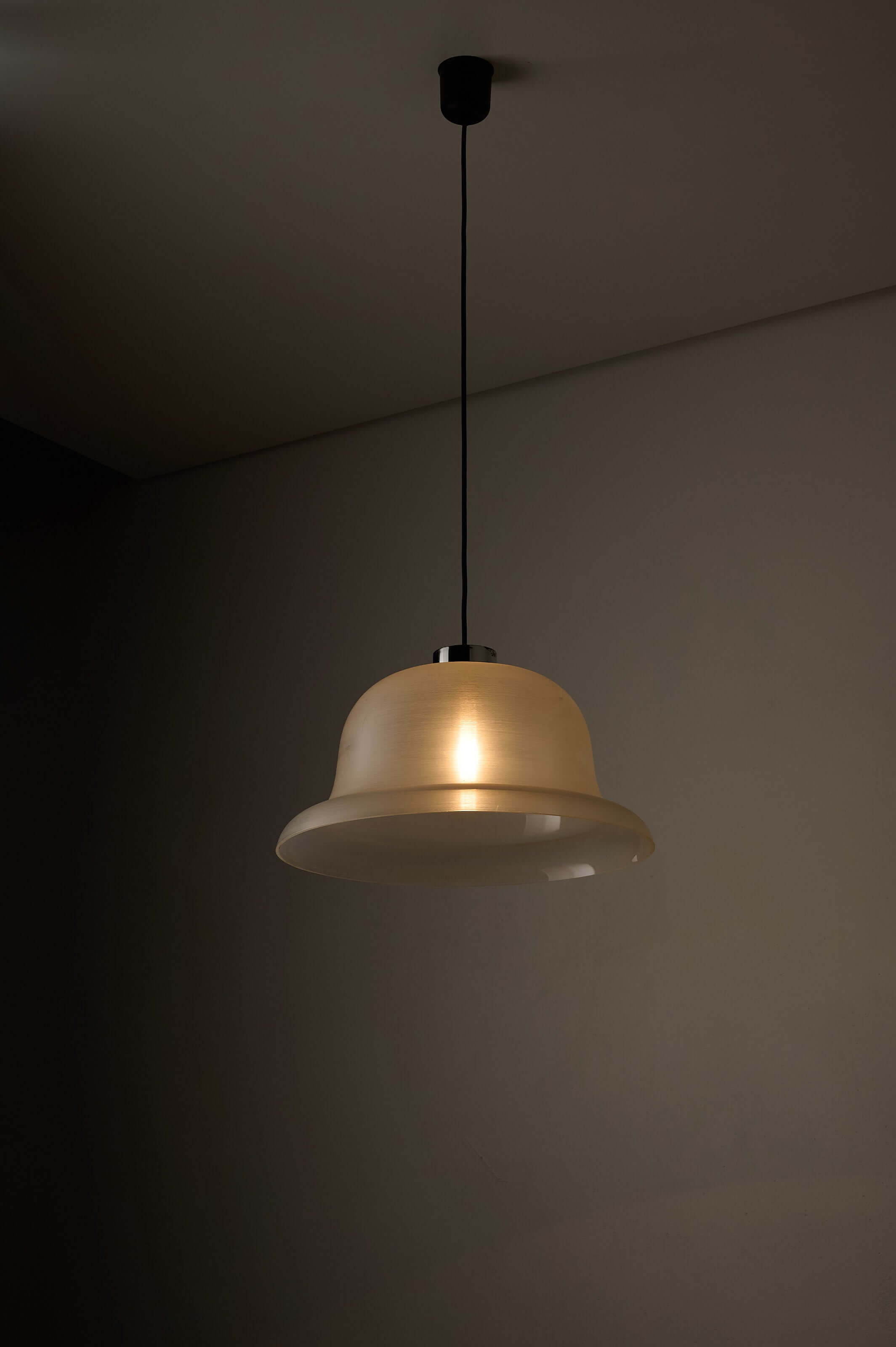 Translucent Acrylic Bell Pendant Lamp, 1970s hanging from a black ceiling in a dimly lit room.