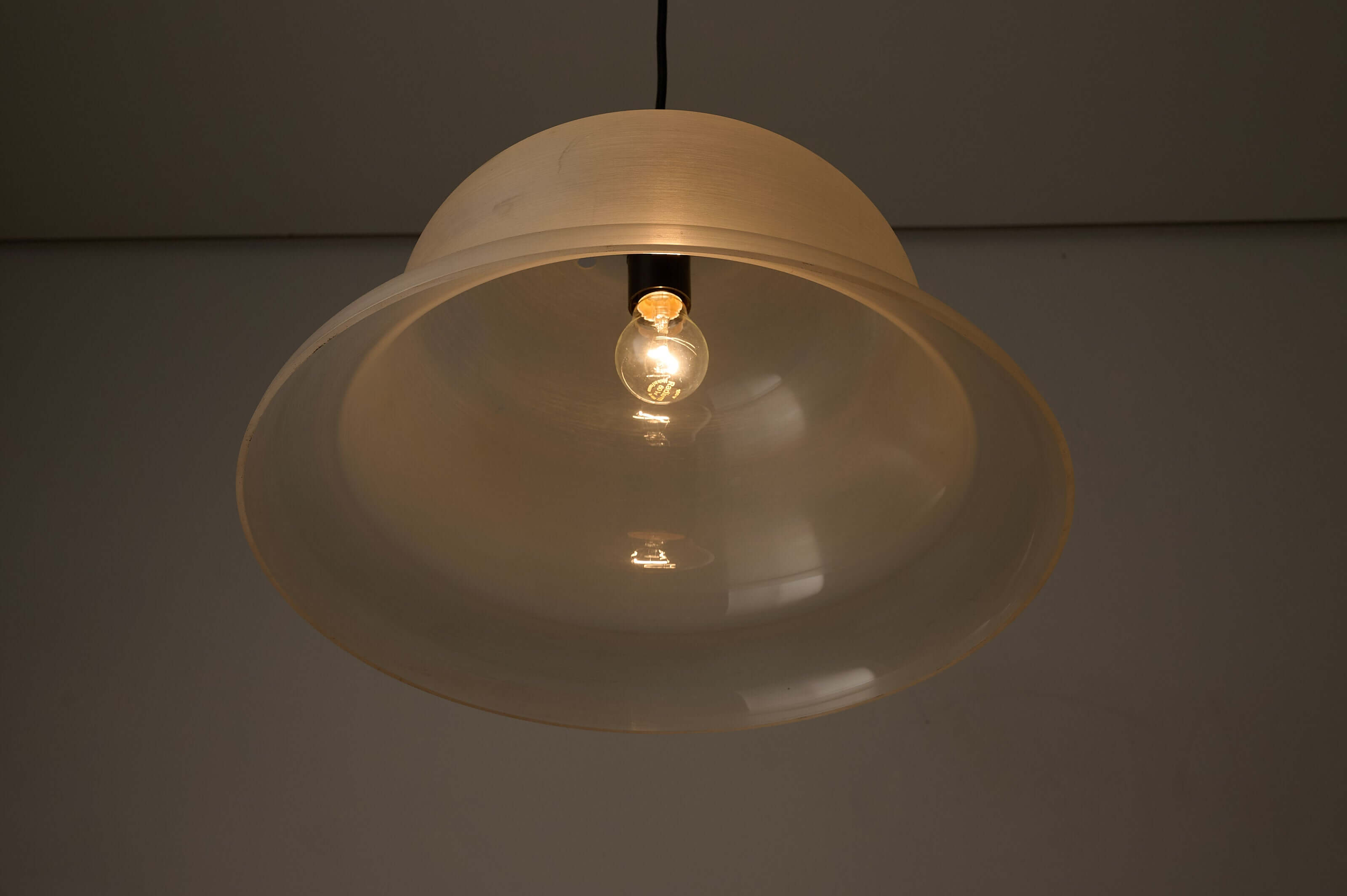Translucent Acrylic Bell Pendant Lamp, 1970s hanging above, showcasing its textured shade and light bulb.