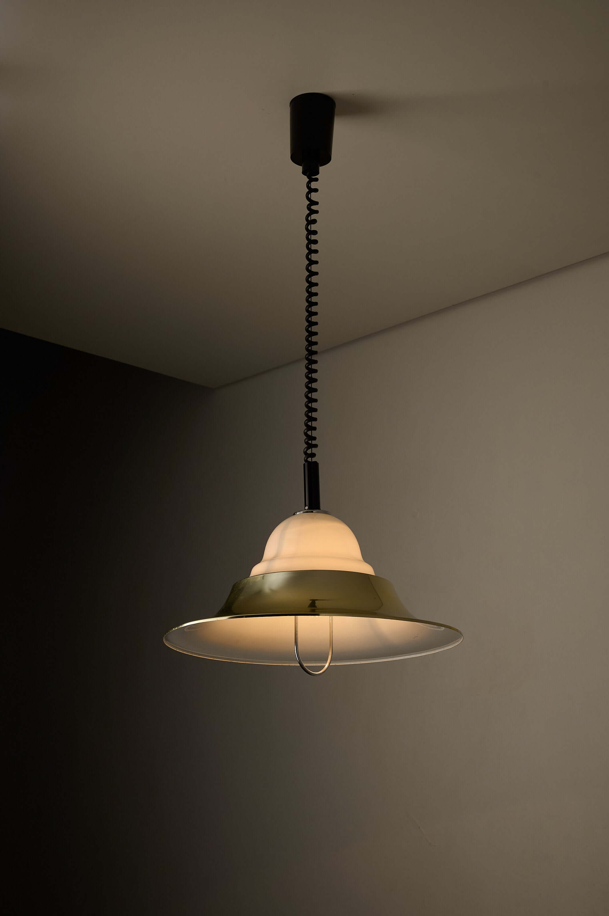 Brass and Opal Glass Model 7565 Pendant Lamp by Cosack hanging from ceiling, showcasing gold-tone shade and milk glass diffuser.
