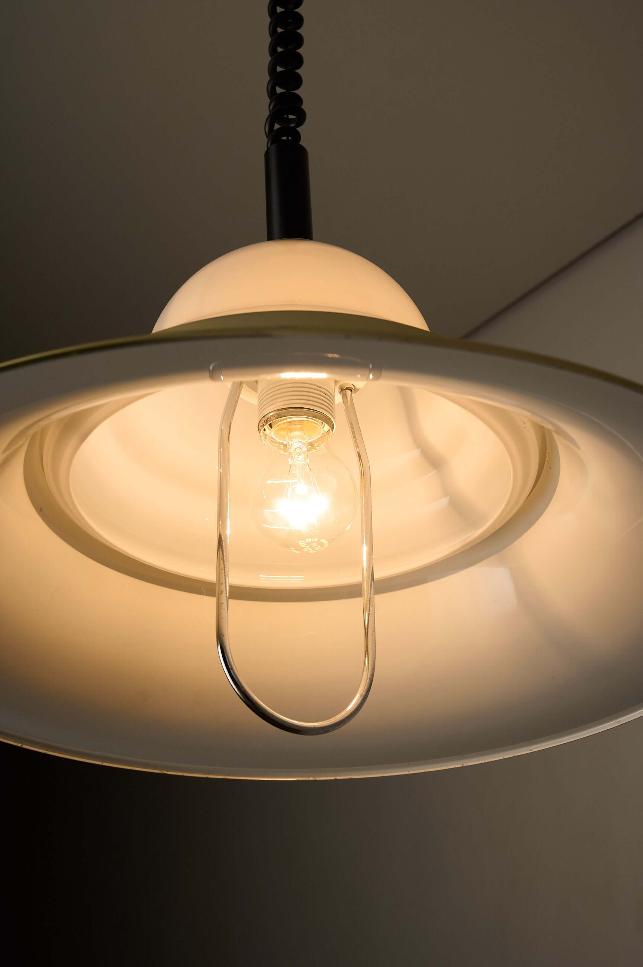 Brass and Opal Glass Model 7565 Pendant Lamp by Cosack with illuminated bulb and milk glass diffuser.
