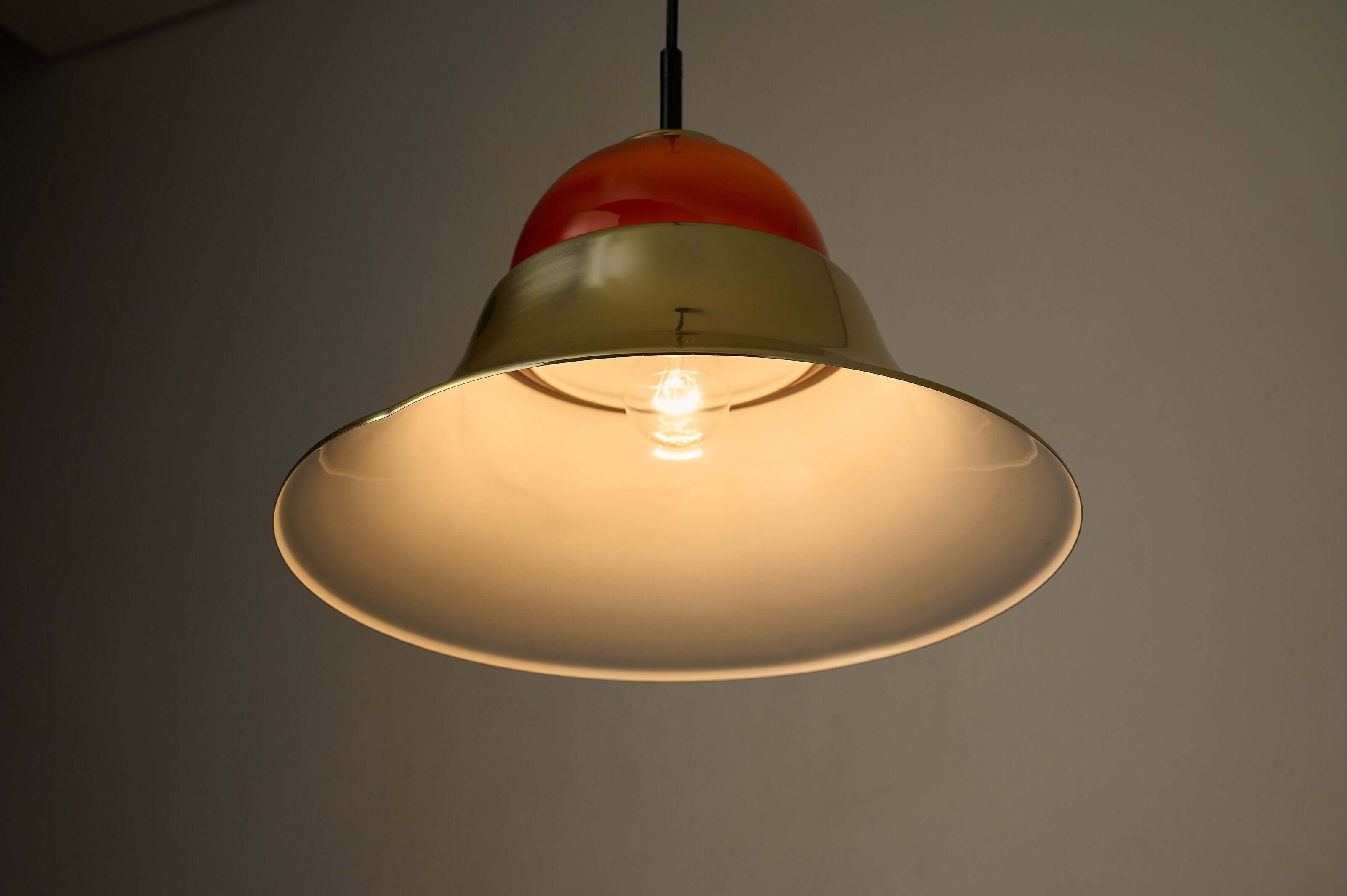 Brass and Amber Glass Model 7563 Pendant by Cosack featuring a polished gold-tone shade and amber glass diffuser.