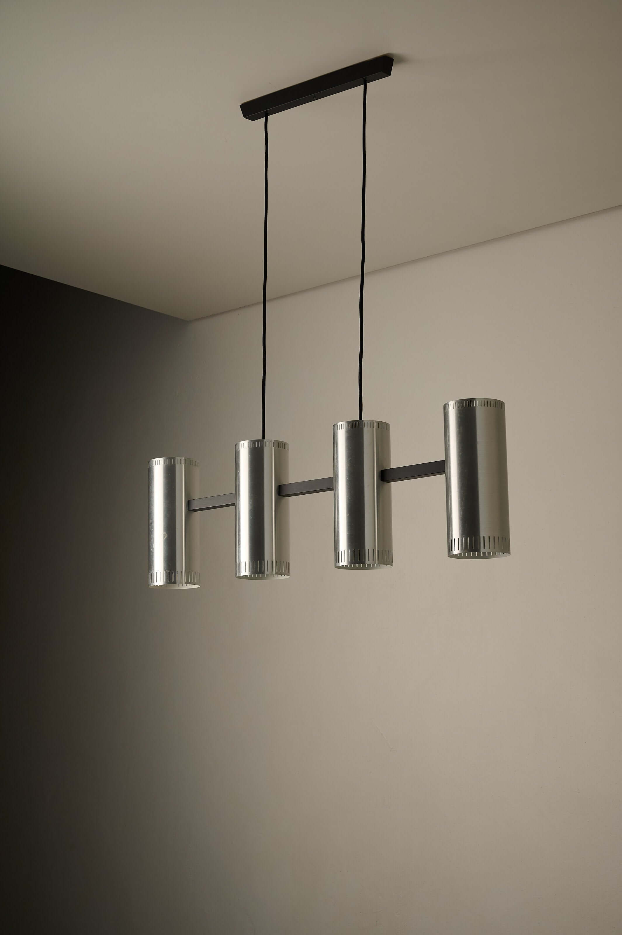 Aluminium "Cylindre IV" 4-Light Linear Pendant by Jo Hammerborg for Fog & Mørup, 1960 hanging from a black ceiling mount.