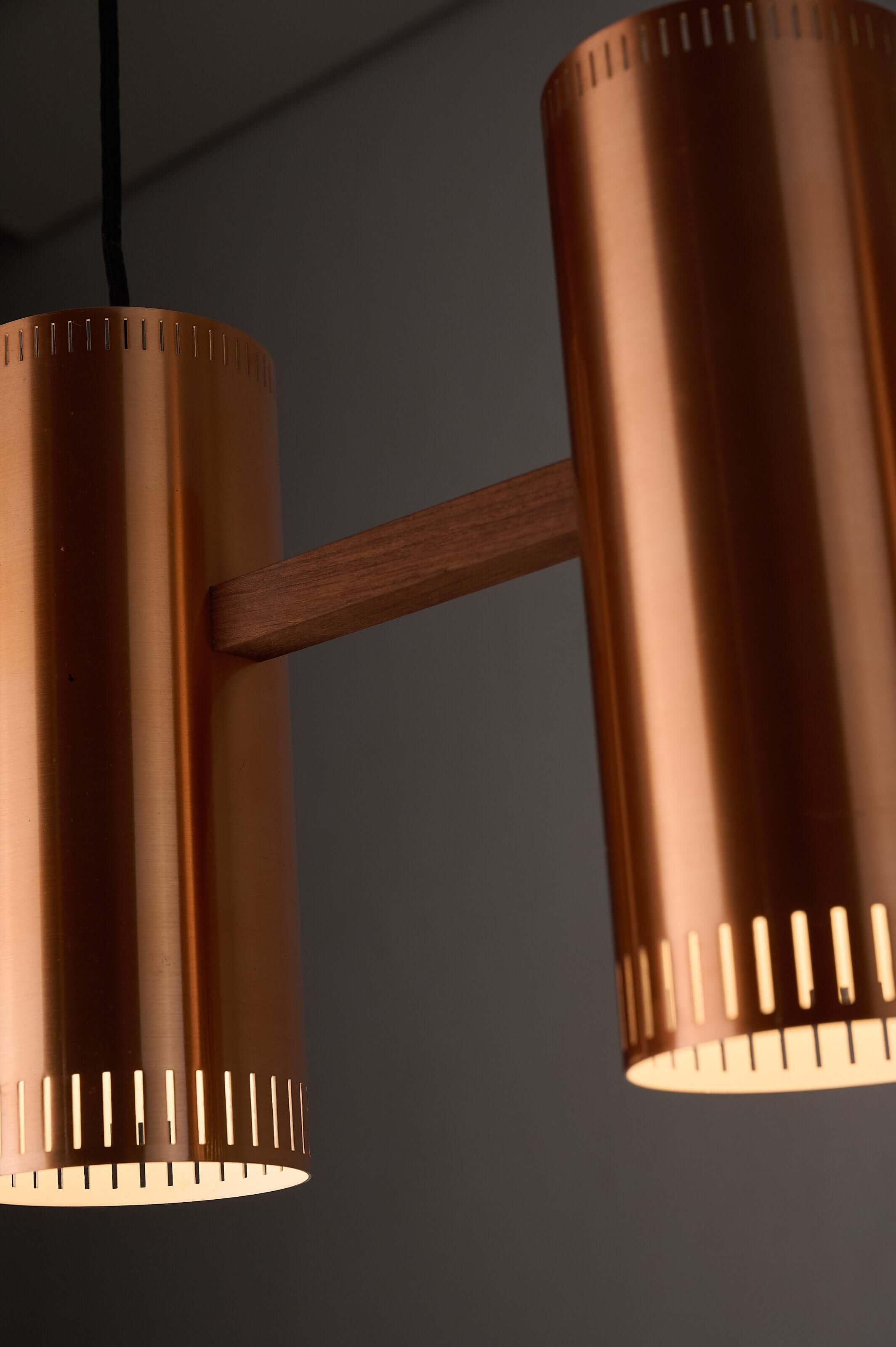 Copper "Cylindre III" 3-Light Linear Pendant by Jo Hammerborg for Fog & Mørup, 1960 showcasing warm copper finish and wooden connecting bar.