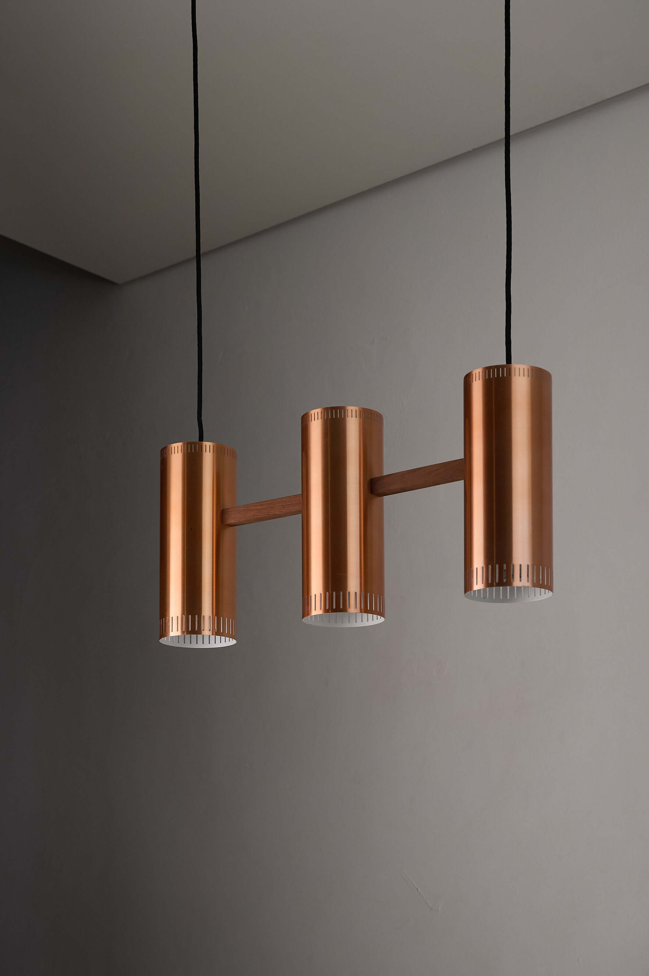 Copper "Cylindre III" 3-Light Linear Pendant by Jo Hammerborg for Fog & Mørup, 1960 featuring warm copper finish and cylindrical shades.