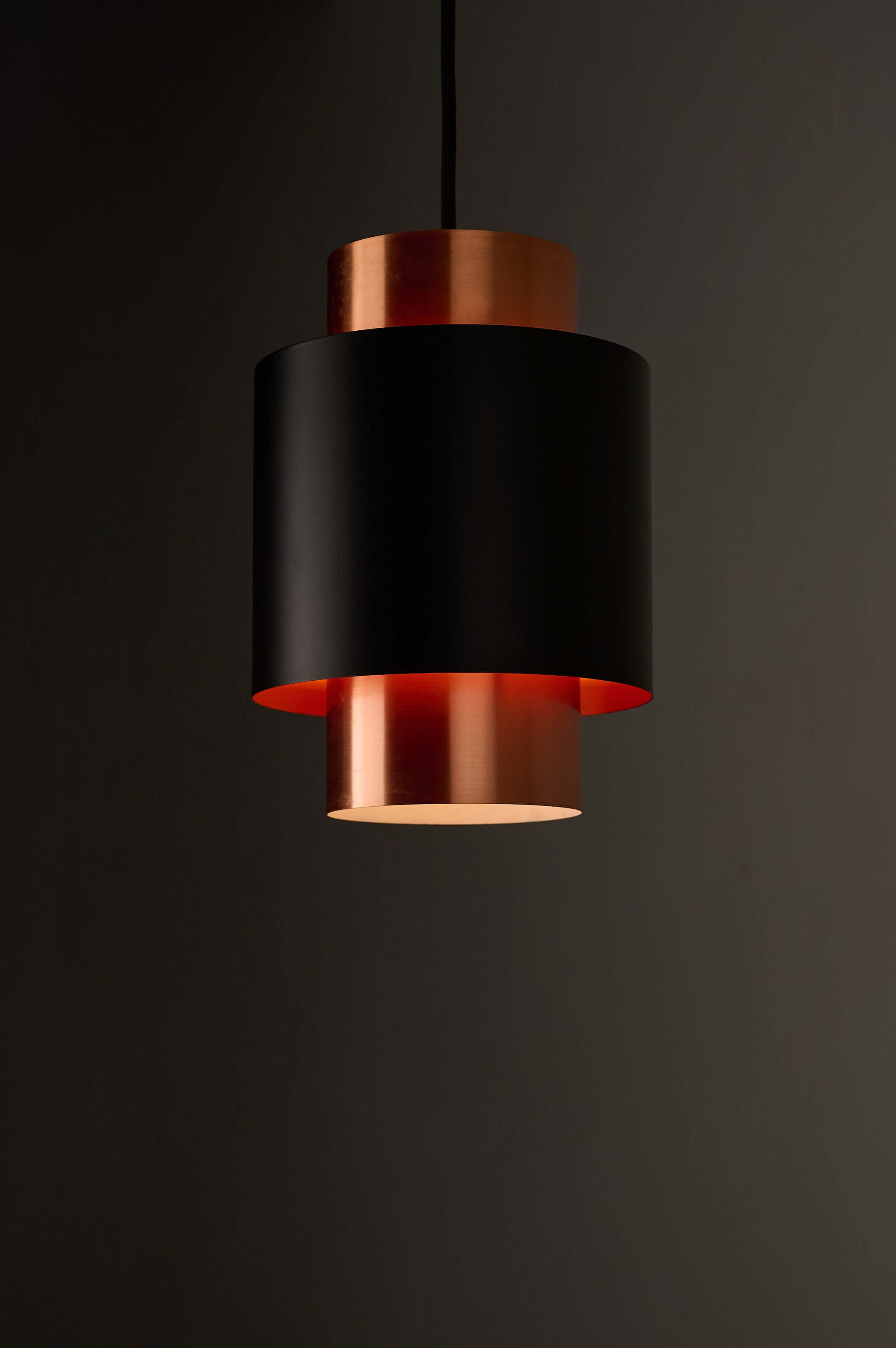 Black and Copper "Tunika" Pendant by Jo Hammerborg for Fog & Mørup, 1960 showcasing layered design and warm lighting.