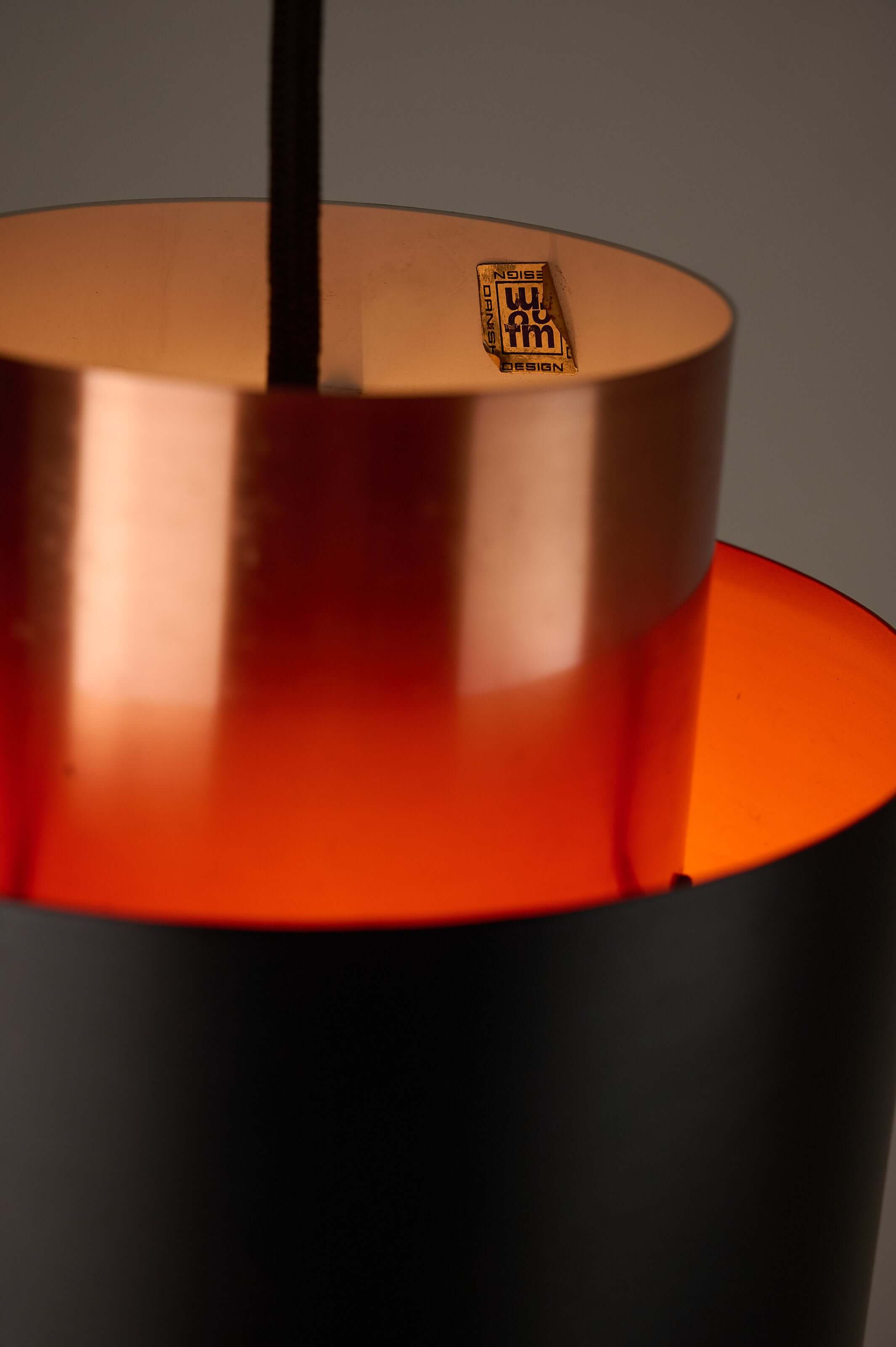Close-up of Black and Copper "Tunika" Pendant by Jo Hammerborg for Fog & Mørup, 1960, showcasing layered materials and light effect.