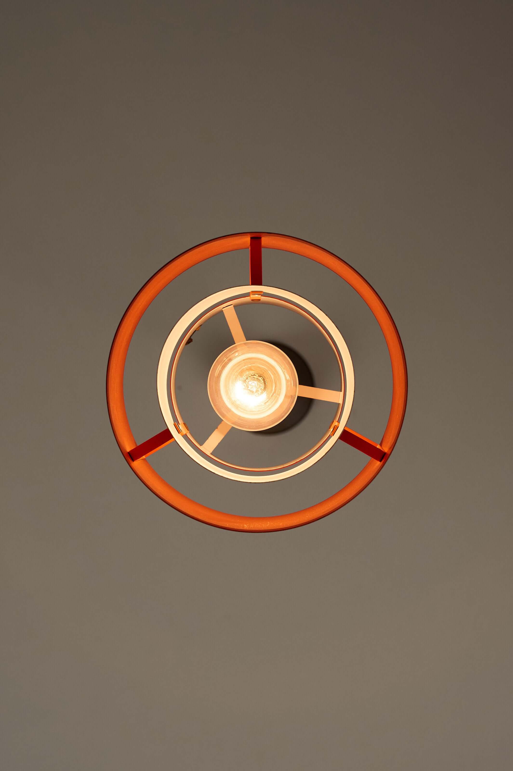 Black and Copper "Tunika" Pendant by Jo Hammerborg for Fog & Mørup, 1960 illuminating a warm orange glow.