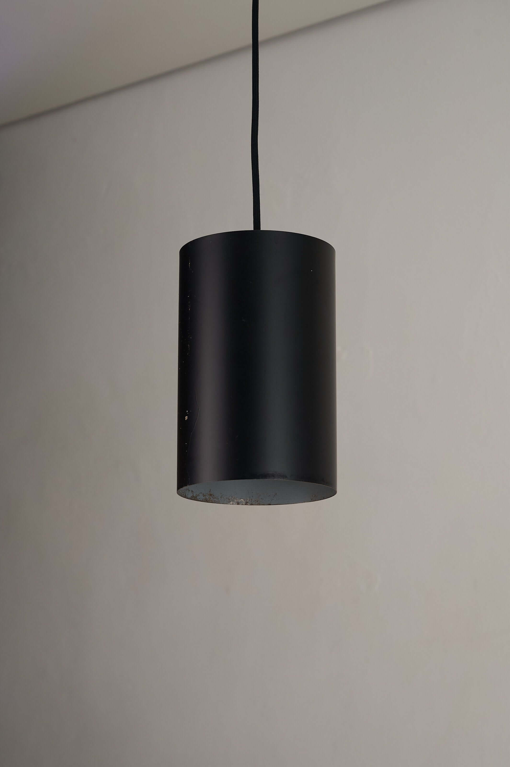 Minimalist Black Cylinder Pendant by Fog & Mørup, 1960s hanging with matte black finish and white interior.
