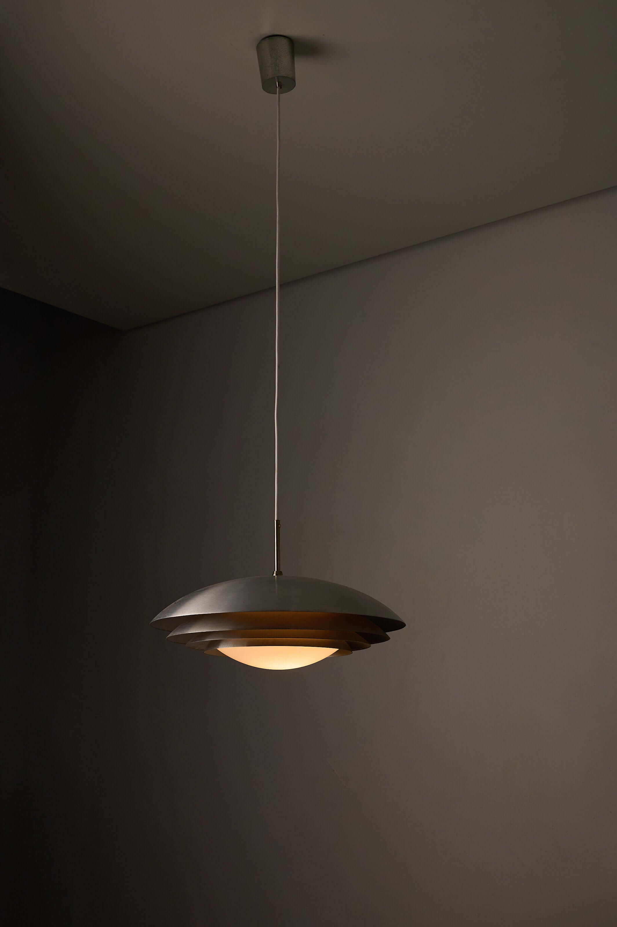 German Space Age "UFO" Pendant in Aluminium and Opal Glass by B+L Leuchten hanging in a modern interior.