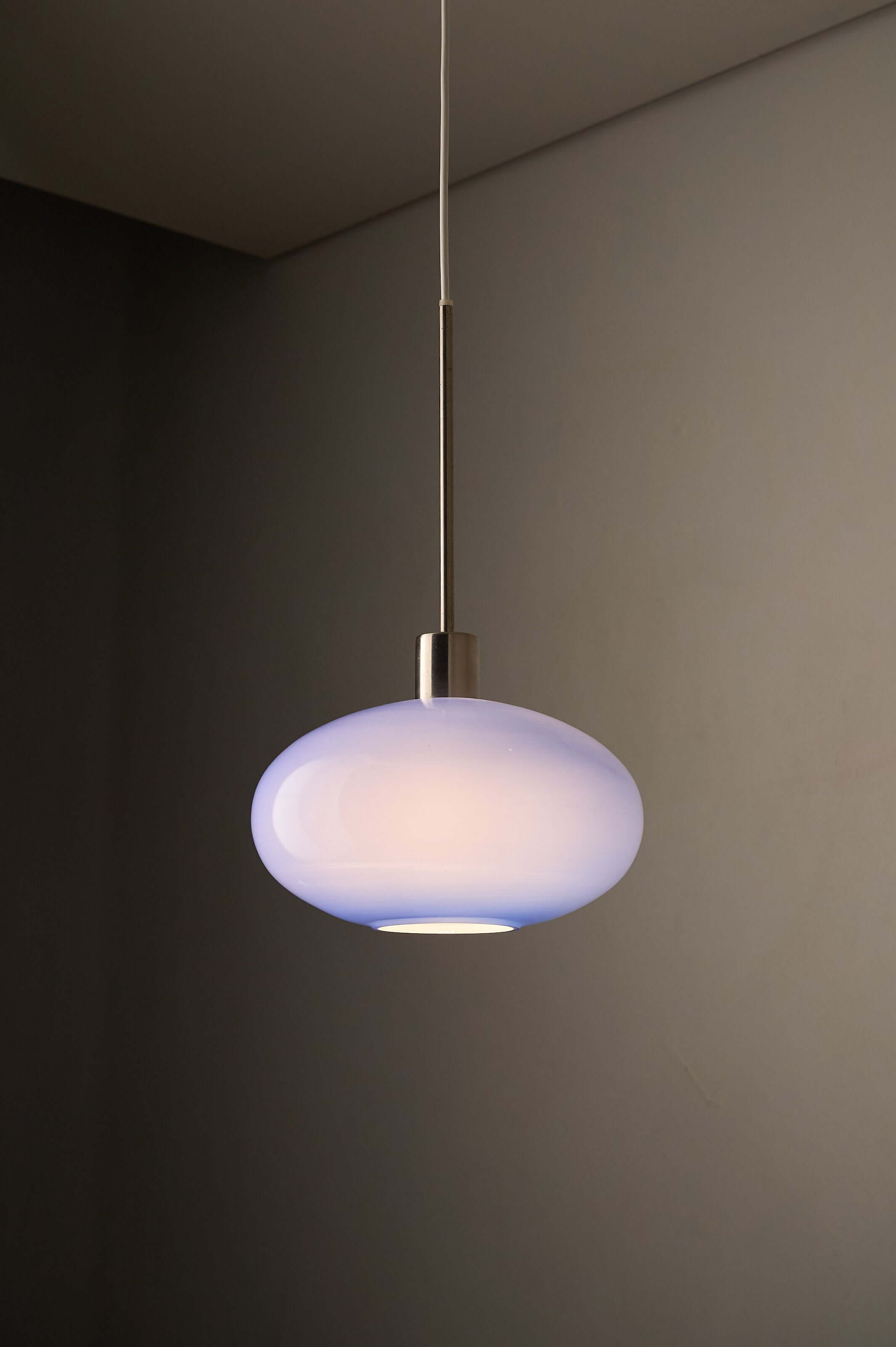 Azure Blue Opaline Glass Pendant with Metal Stem hanging light in a modern interior setting.