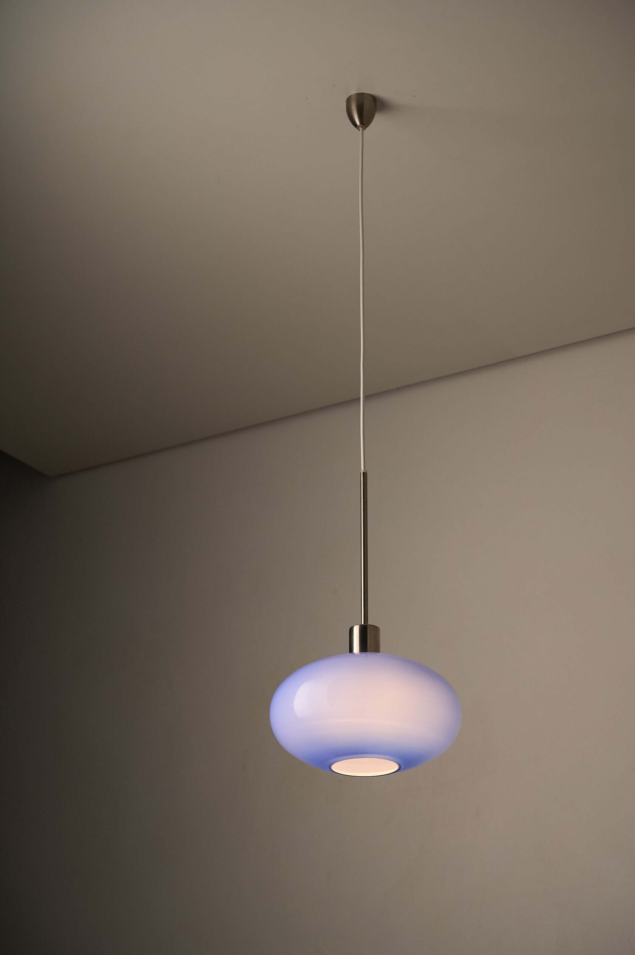 Azure Blue Opaline Glass Pendant with Metal Stem hanging from the ceiling against a neutral background.