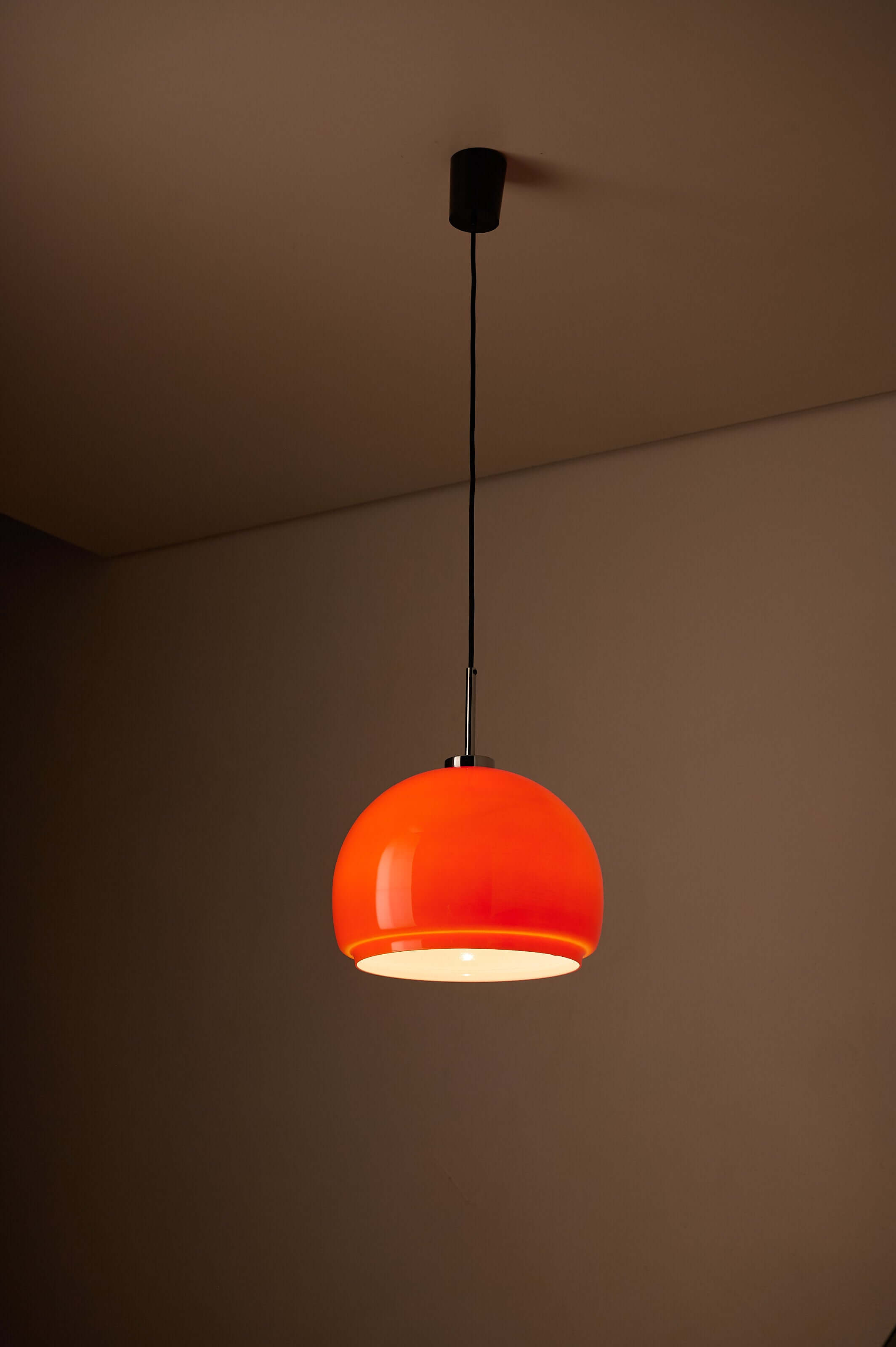 Orange Opaline Glass Pendant by Fog & Mørup hanging from a ceiling, showcasing vibrant orange and opal design.