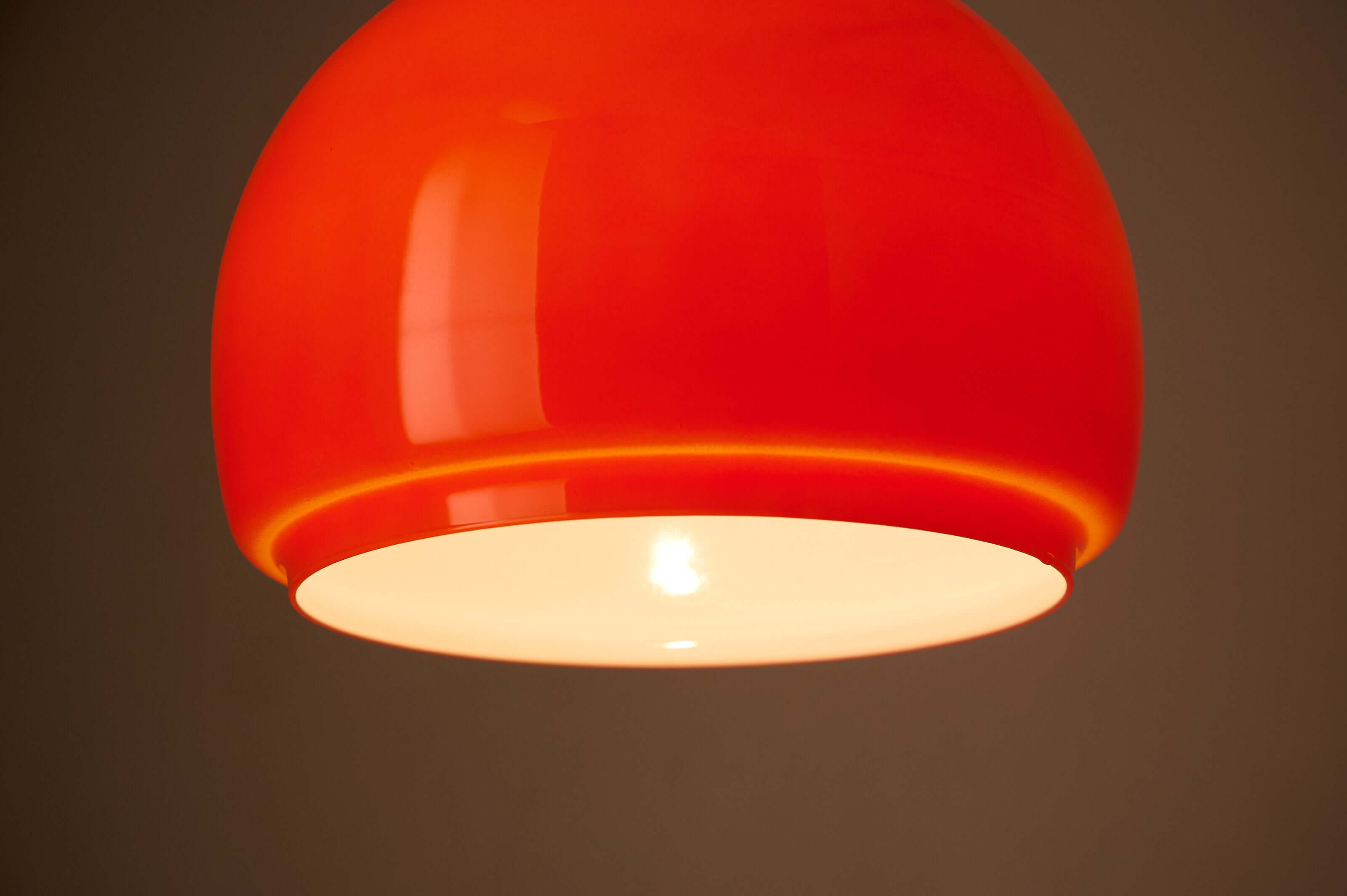 Orange Opaline Glass Pendant by Fog & Mørup illuminating a space with its vibrant tangerine hue.