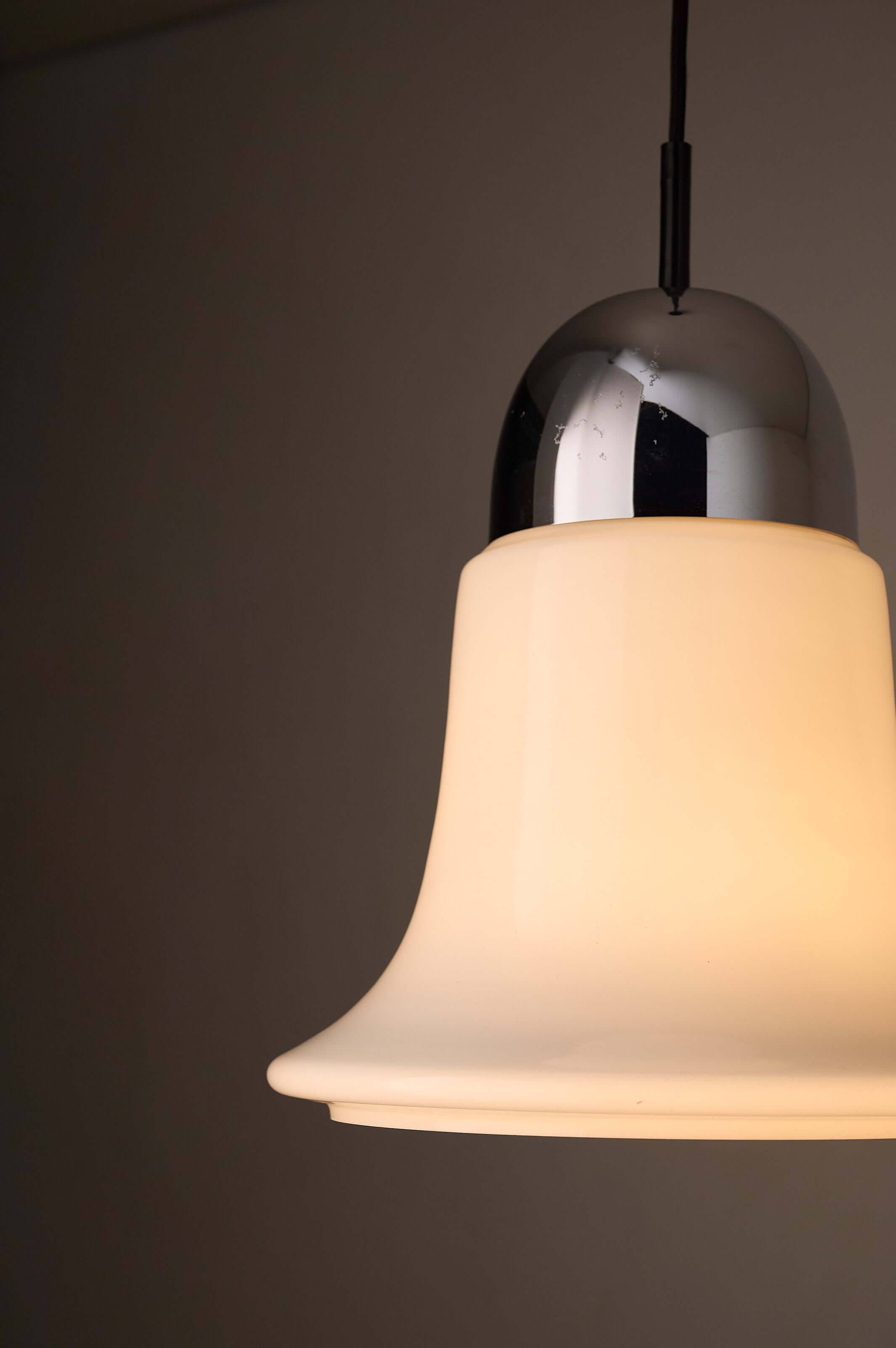 Mid-Century Opaline Glass & Chrome Bell Pendant light highlighting its elegant design and soft glow.