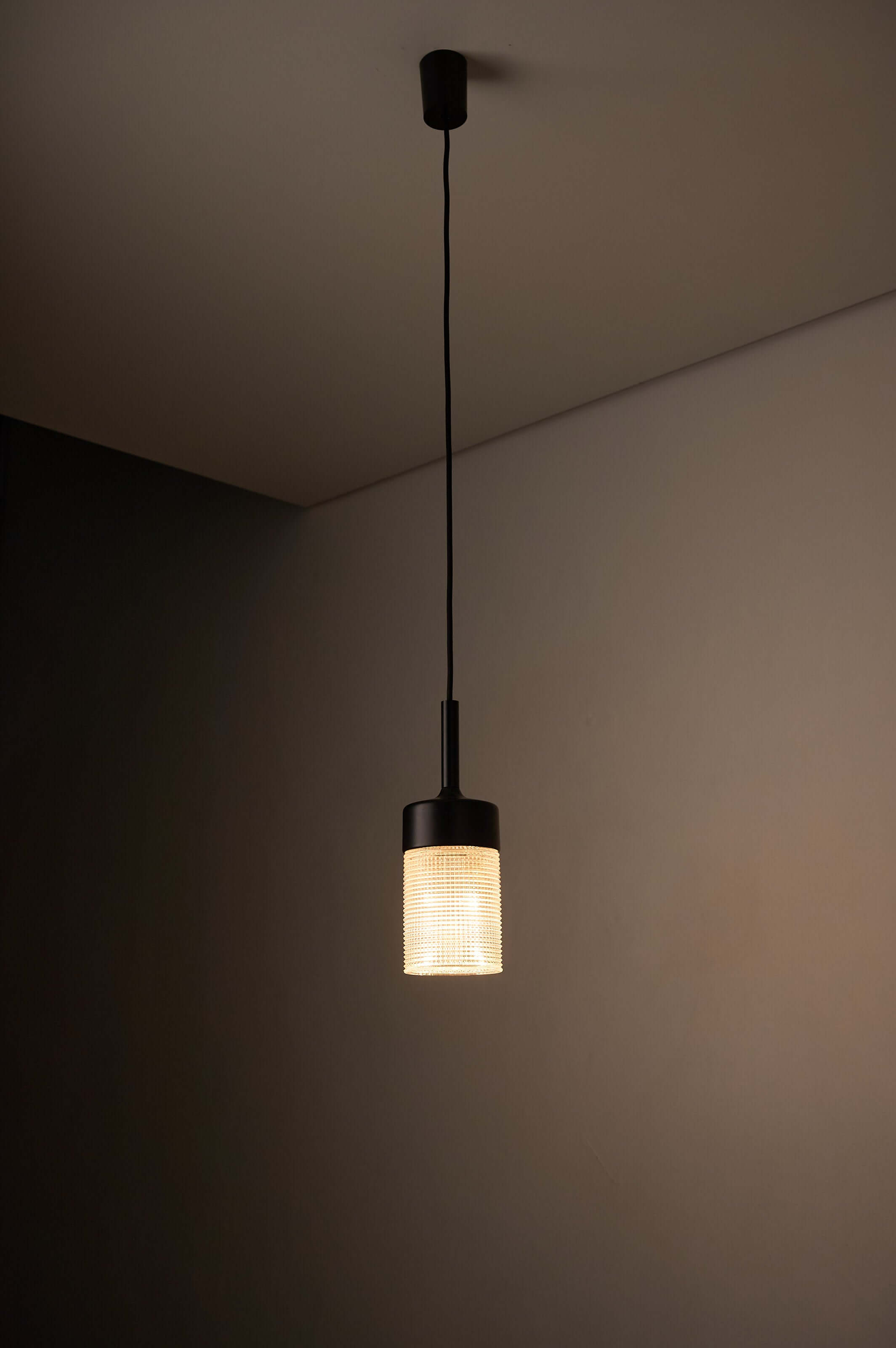Black Model "7480" structured glass pendant light by Cosack, showcasing cylindrical design and geometric glass texture.