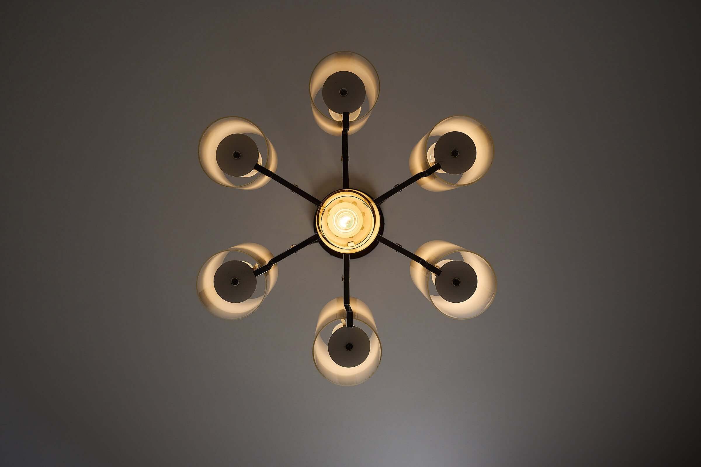 Space Age chrome chandelier with six cylindrical shades, showcasing polished chrome and opaline glass design.