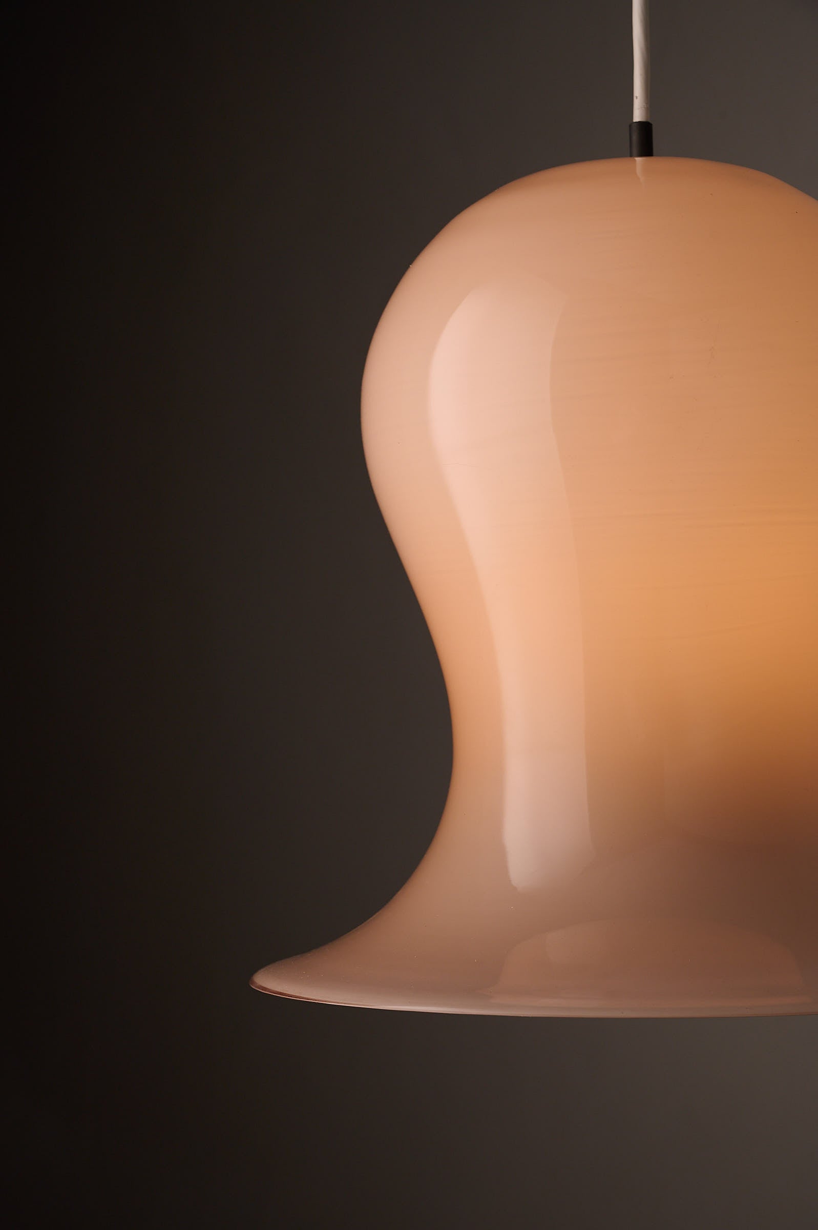 Bell-Shaped Glass Pendant in Dusty Rose, 1970s featuring a unique hand-blown design and smooth, fluid silhouette.
