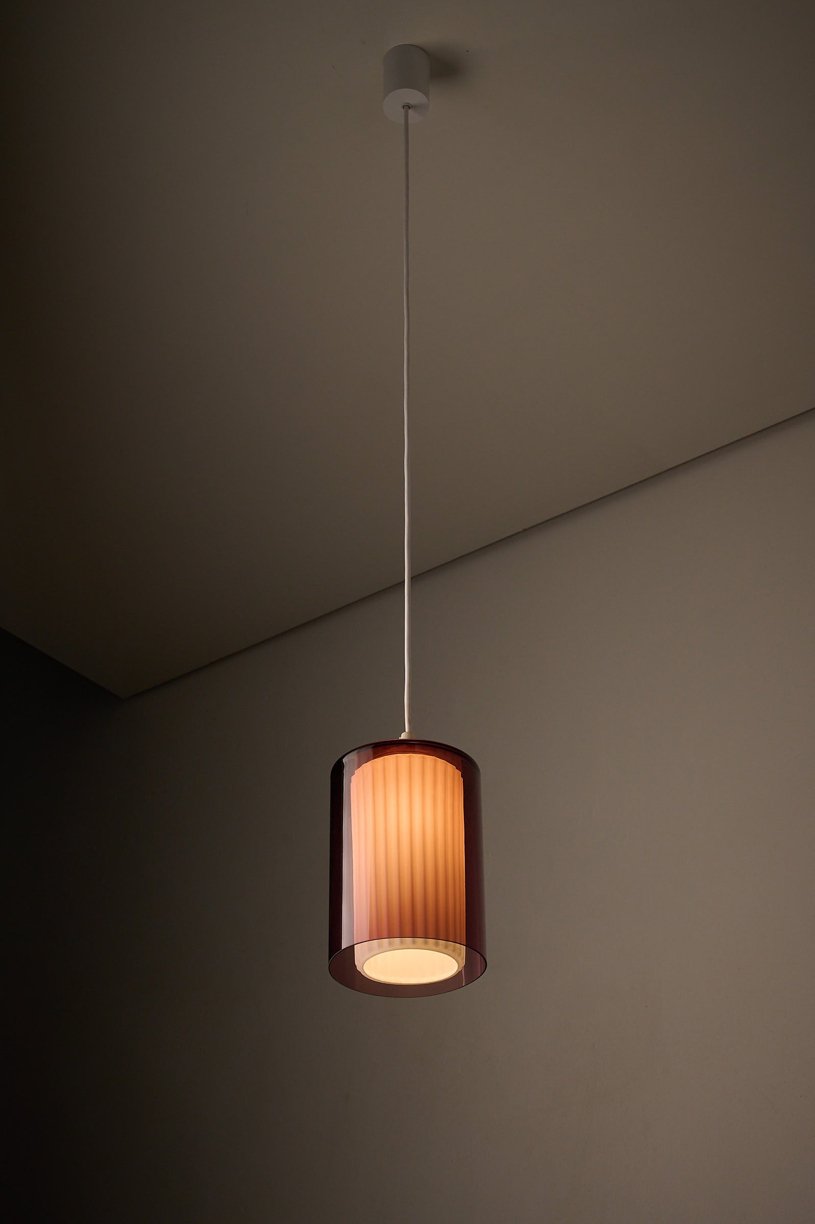 Double Glass Pendant in Lilac and Opaline, Europe, 1960s/1970s hanging from ceiling.