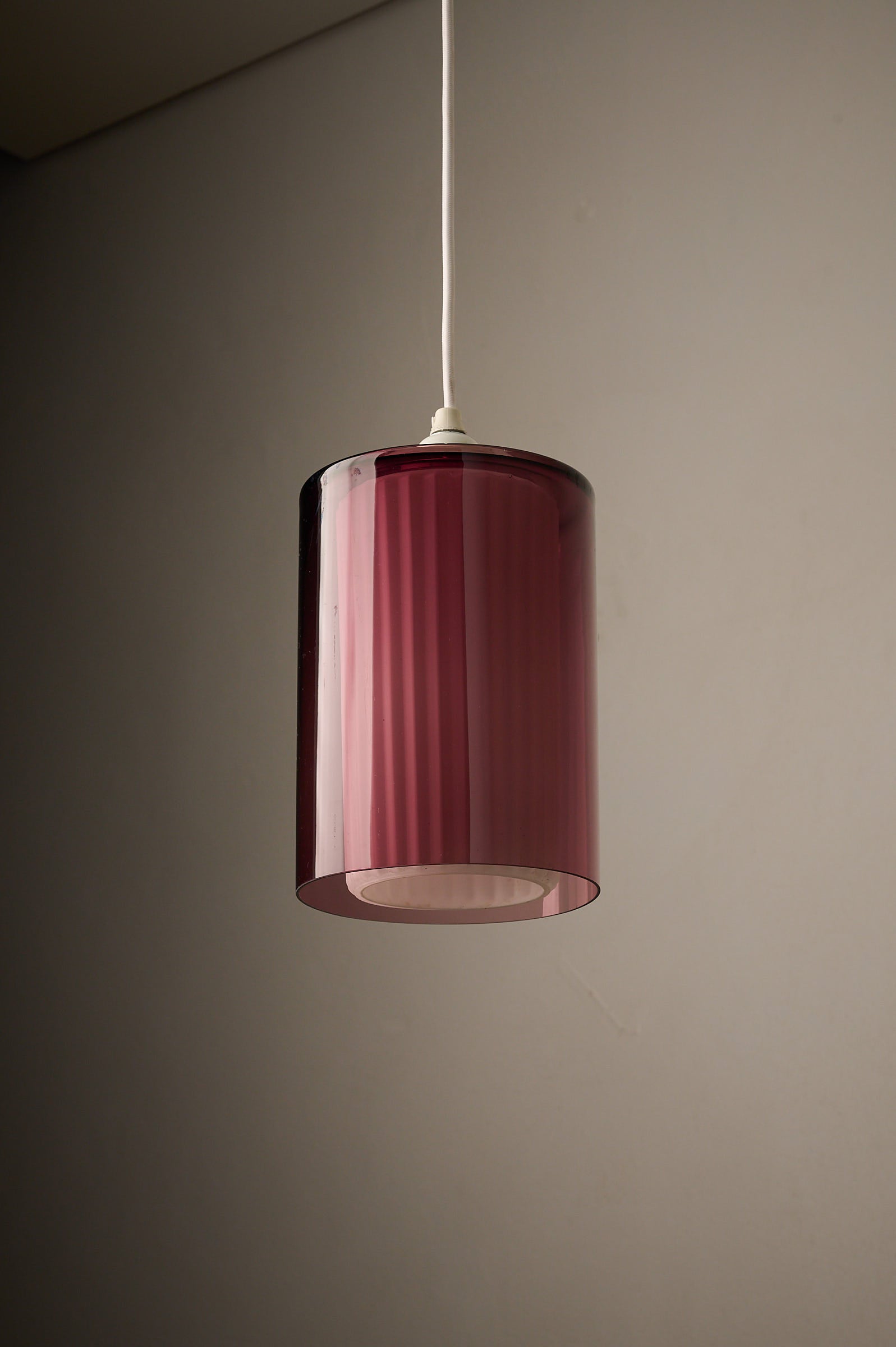 Double Glass Pendant in Lilac and Opaline, Europe, 1960s/1970s hanging lamp with deep lilac glass exterior.