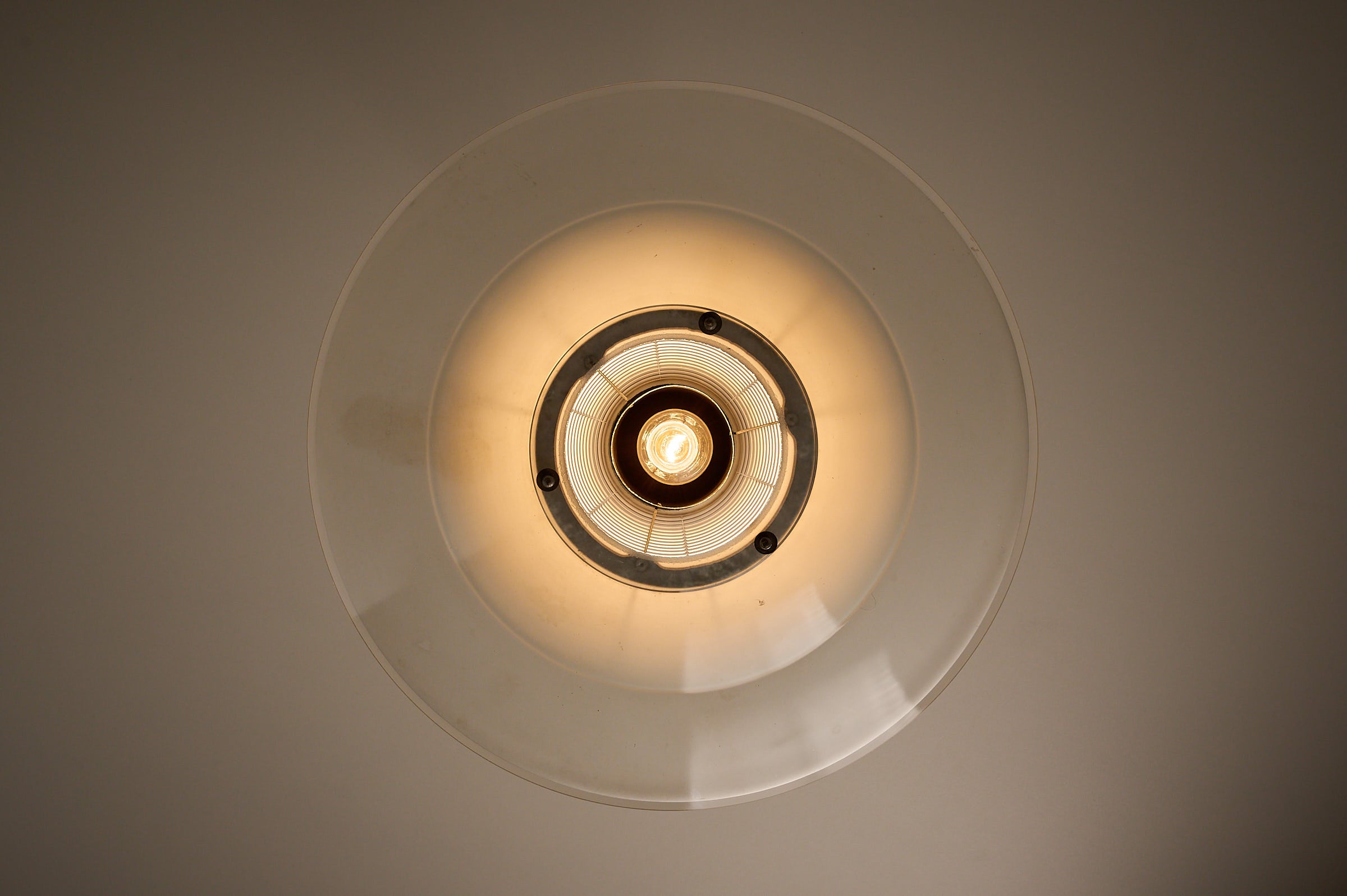 Art Deco Industrial Pendant, 1930s viewed from below, featuring layered glass shades for optimal light diffusion.