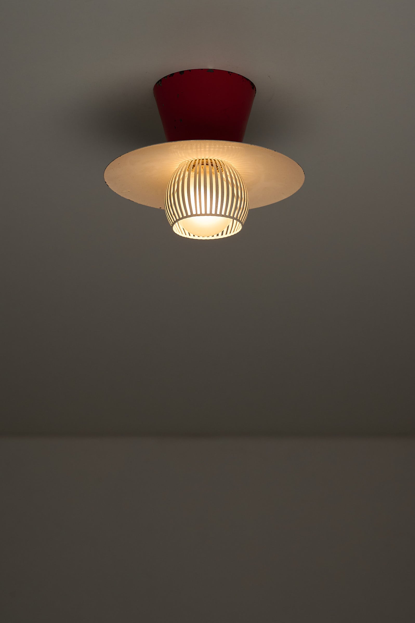Mid-Century Flush Mount Ceiling Lamp with White Slatted Diffuser featuring a red cone canopy and slatted metal diffuser.