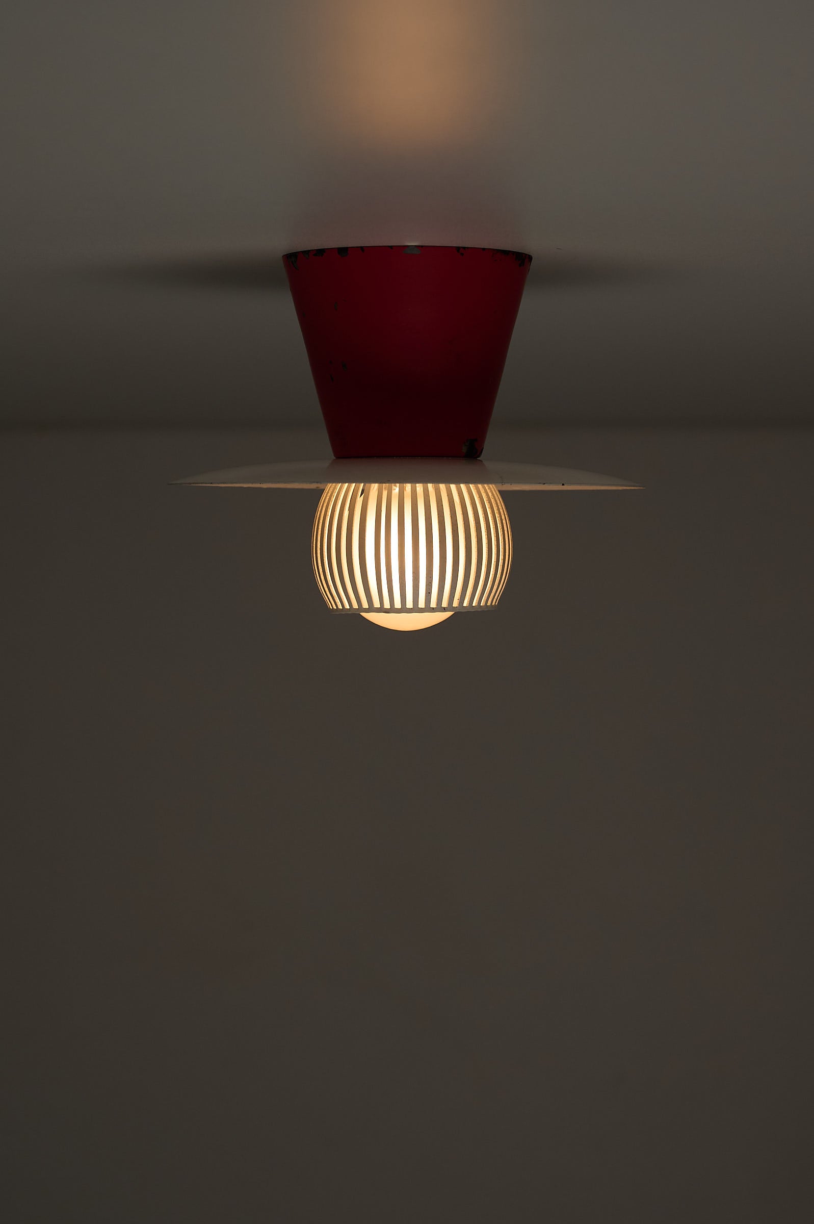 Mid-Century Flush Mount Ceiling Lamp with White Slatted Diffuser featuring red cone canopy and slatted metal diffuser.