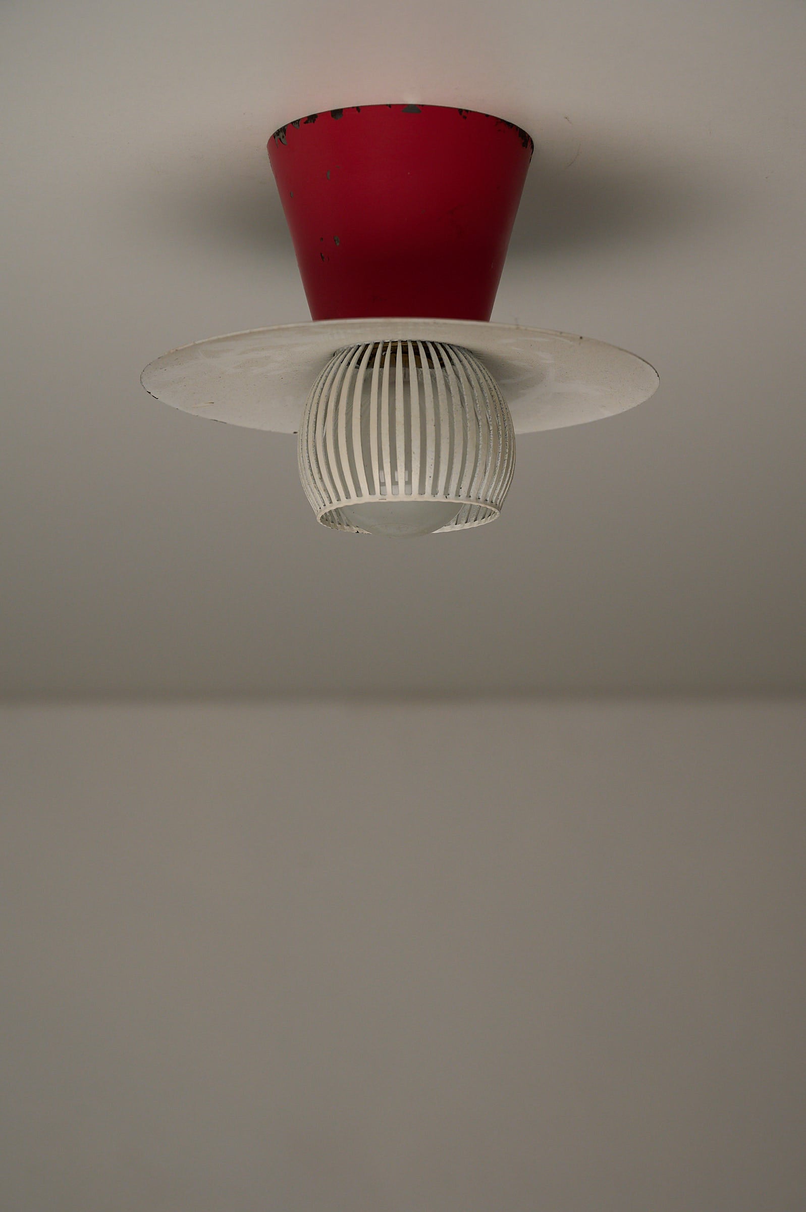 Mid-Century Flush Mount Ceiling Lamp with White Slatted Diffuser featuring red truncated cone and slatted metal cage.