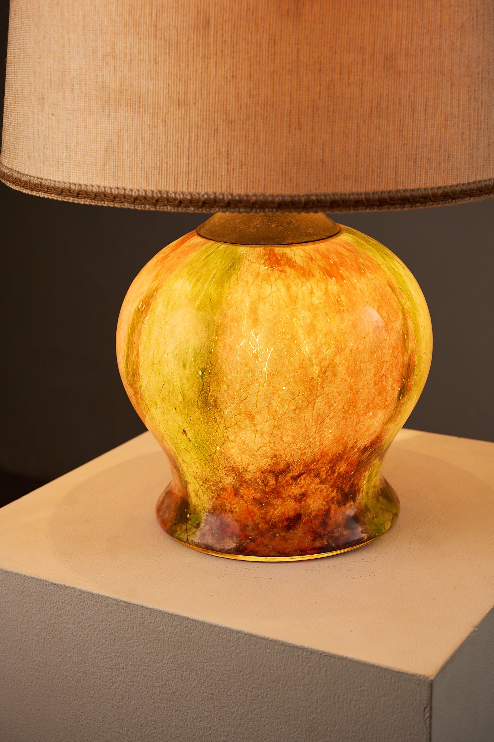 1970s Mid-Century Modern Multicolored Art Glass Table Lamp with a glowing amber and green glass base.