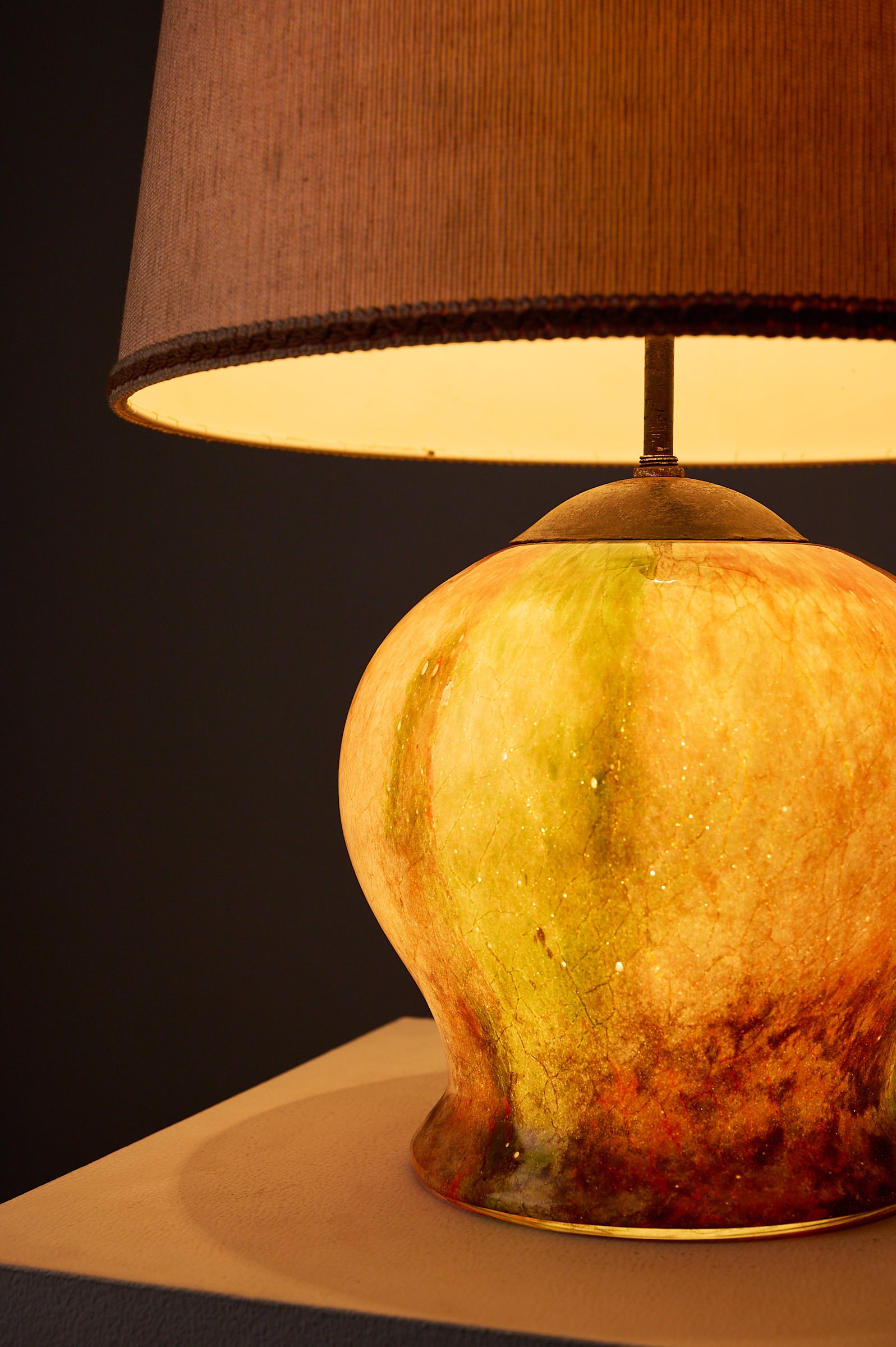 1970s Mid-Century Modern Multicolored Art Glass Table Lamp featuring a glowing marbled amber and emerald base.