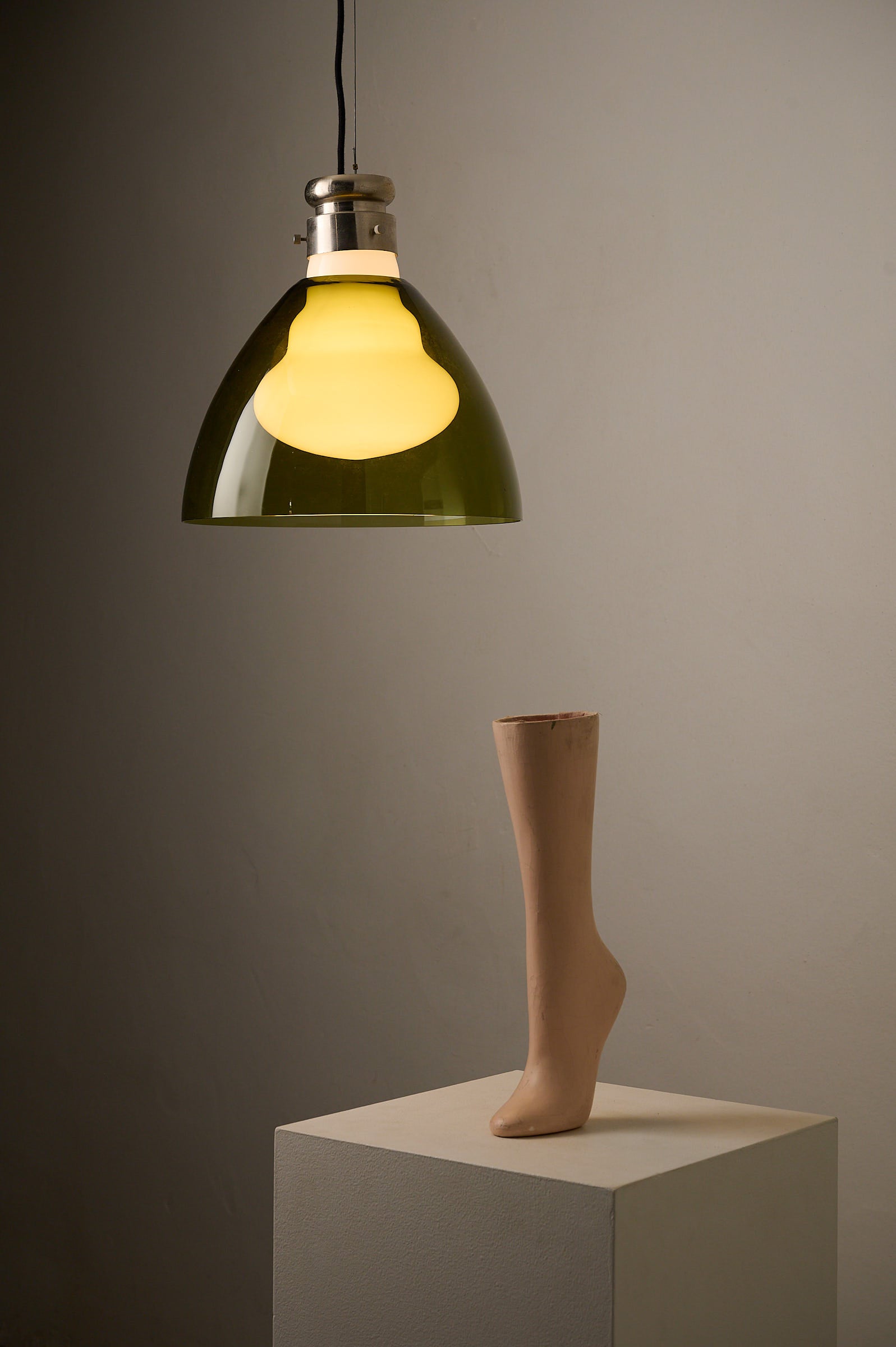 Space Age Blown Glass Pendant Lamp by Vistosi, Italy, 1970s illuminating a display with a mannequin foot.