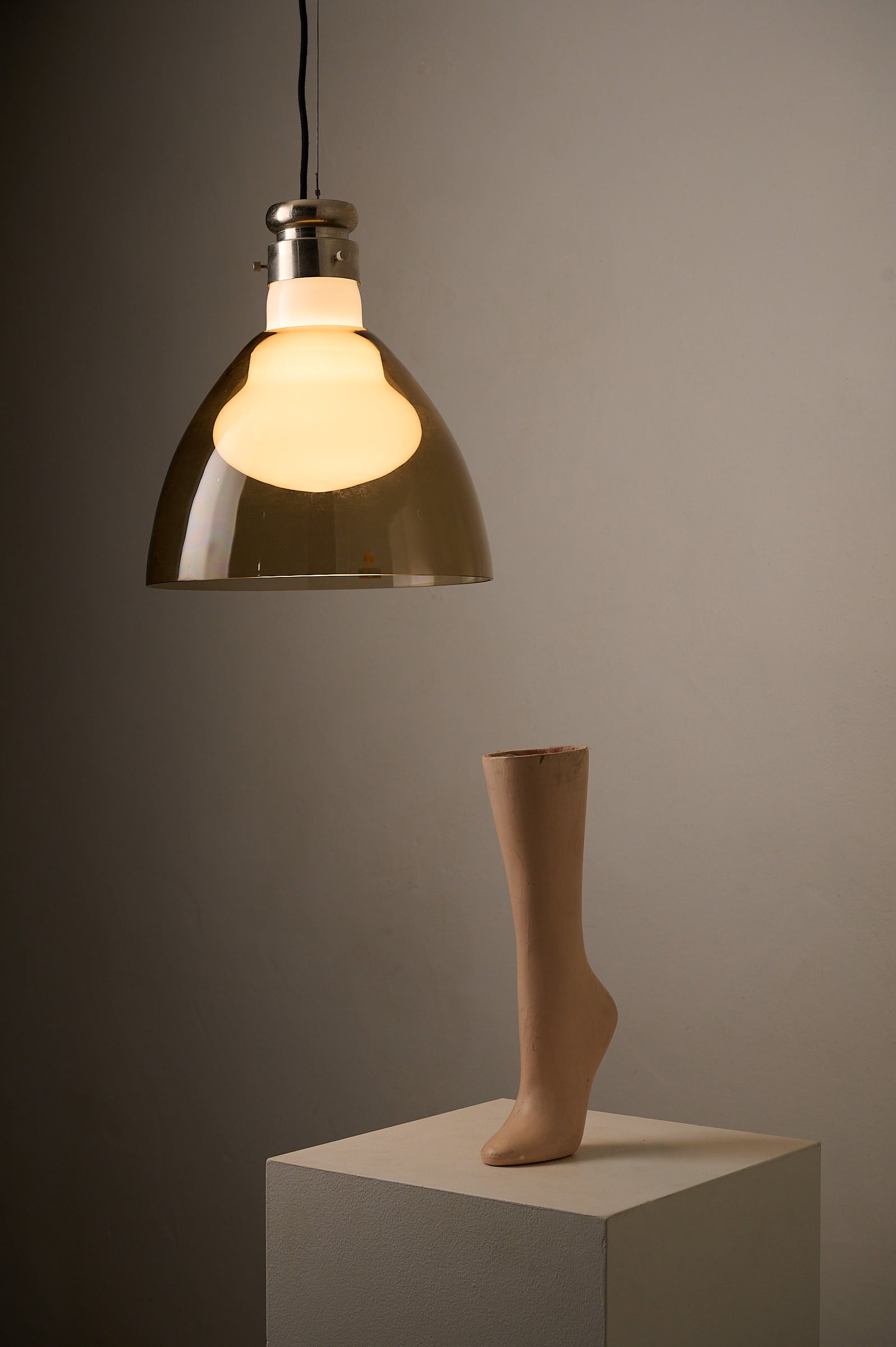 Space Age Blown Glass Pendant Lamp by Vistosi, Italy, 1970s hanging above a mannequin leg on a pedestal.