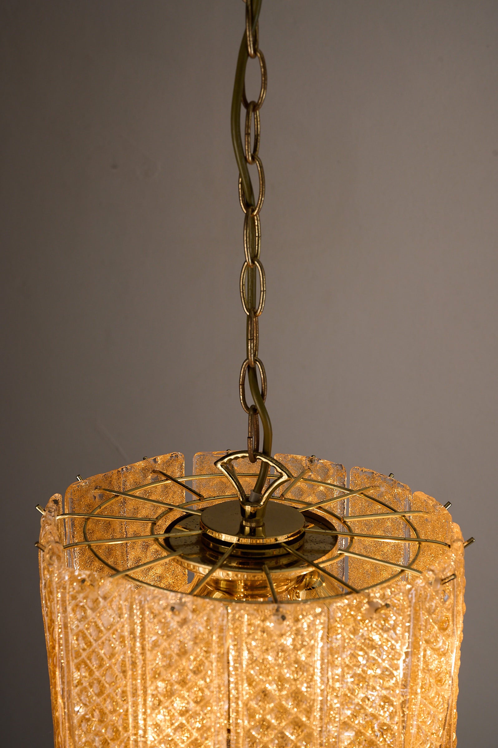Textured Yellow Glass Panel Chandelier, Europe, 1970s with geometric glass panels and warm ambient glow.