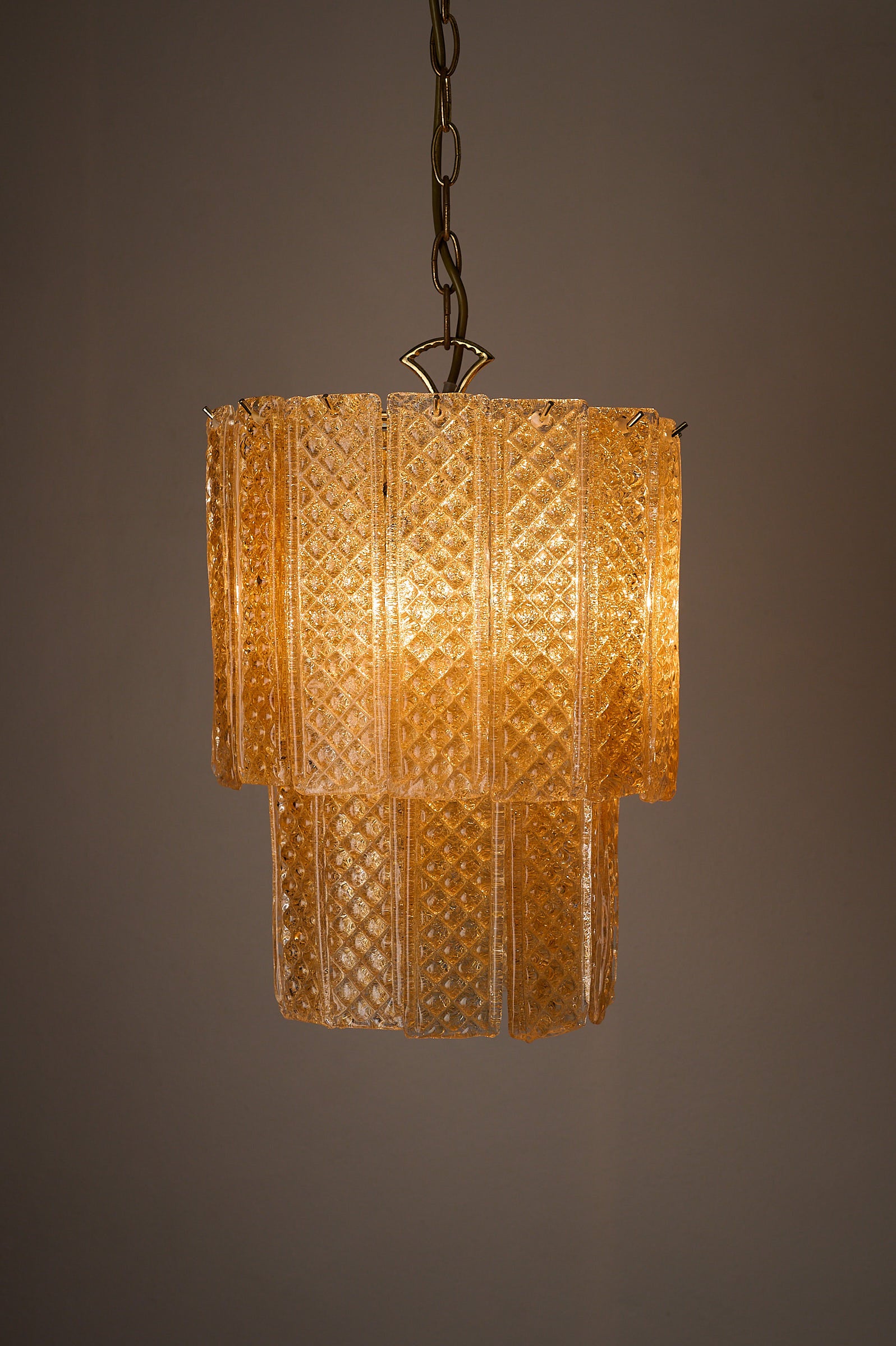 Textured Yellow Glass Panel Chandelier, Europe, 1970s illuminating a warm glow.