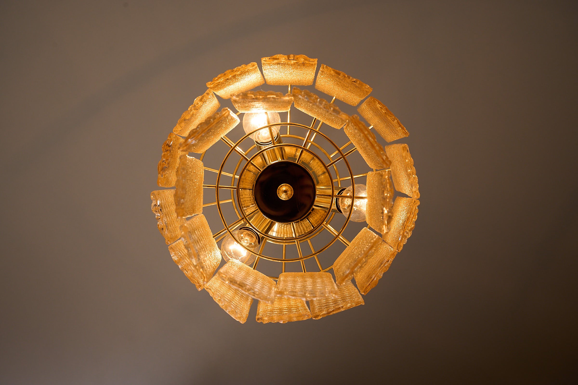 Textured Yellow Glass Panel Chandelier, Europe, 1970s with geometric glass panels and warm ambient glow.