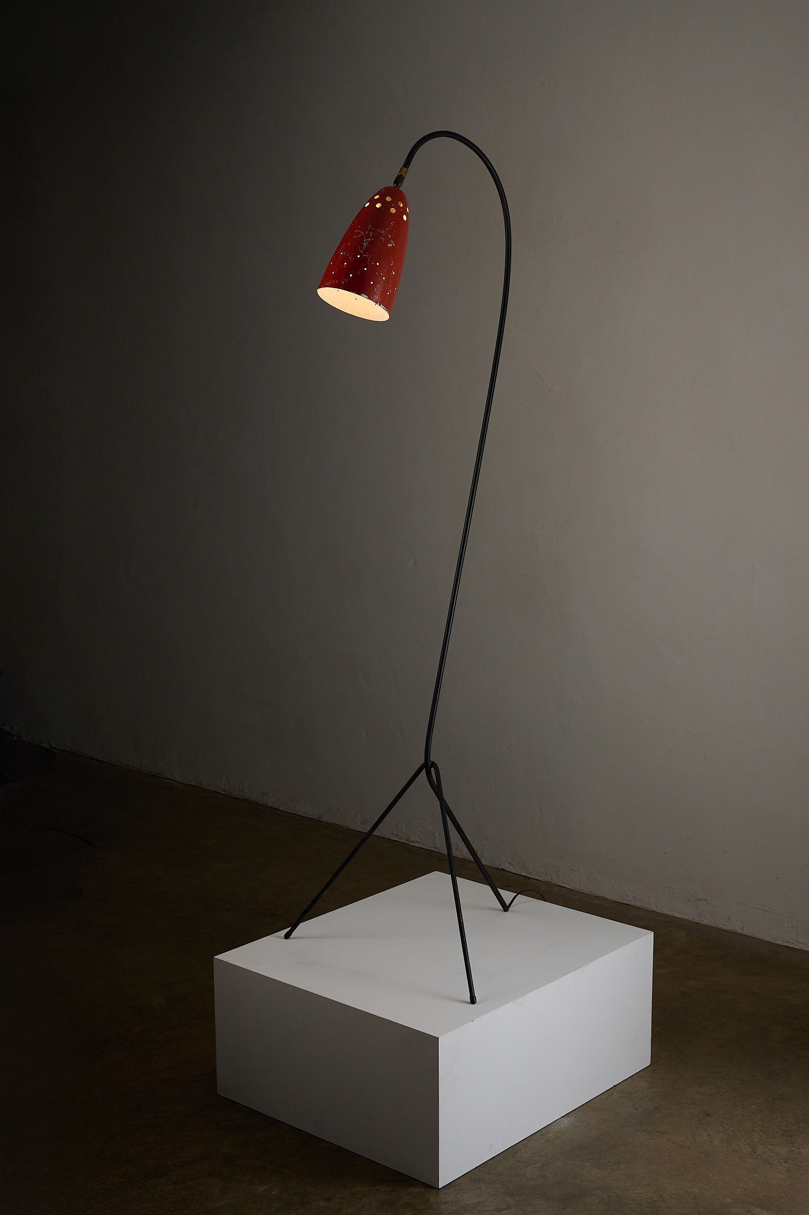 'Grasshopper' Floor Lamp, The Netherlands, 1950s with a red shade and black tripod base.