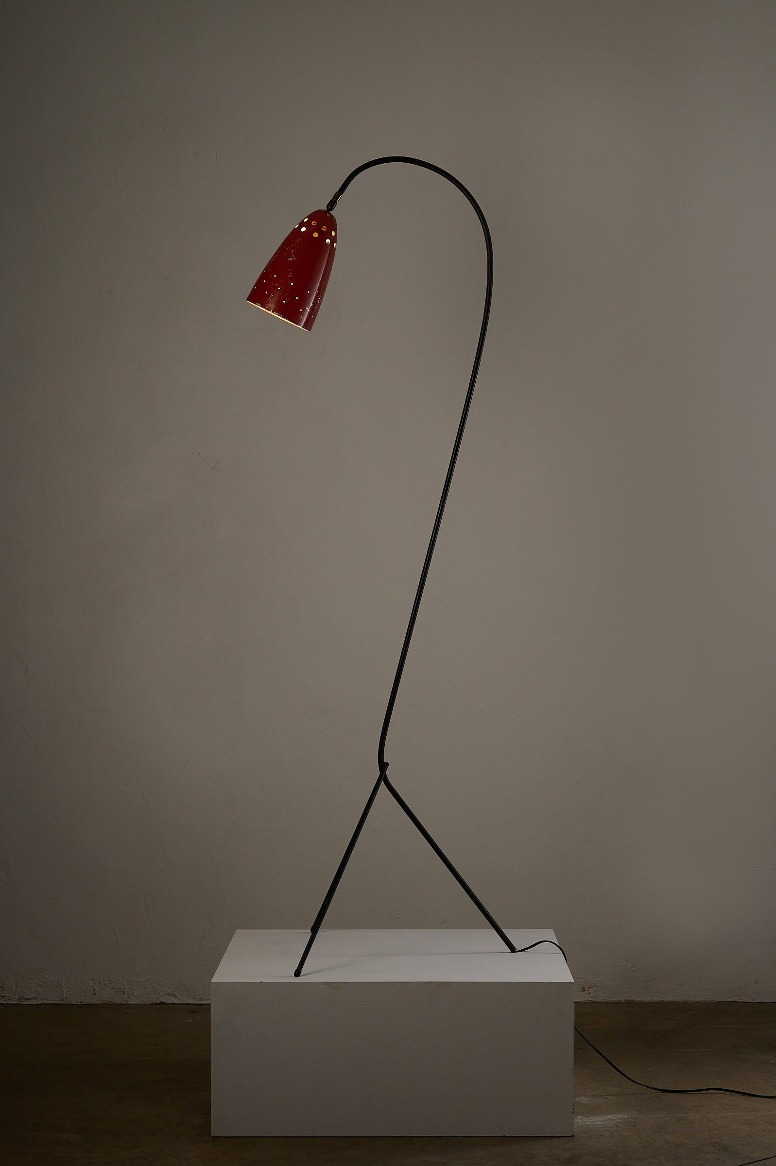 'Grasshopper' Floor Lamp, The Netherlands, 1950s with a black tripod chassis and red lacquered shade.