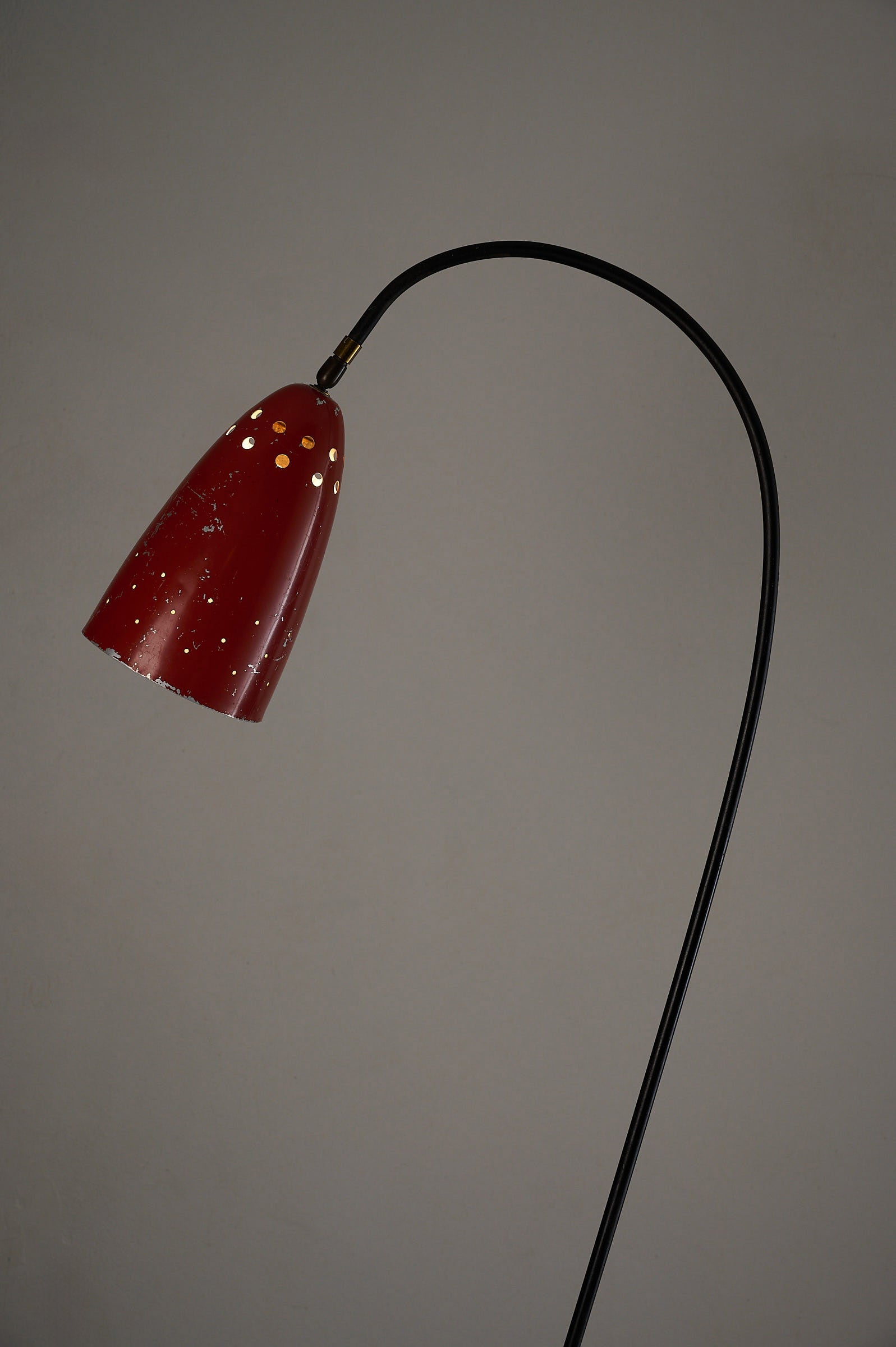 'Grasshopper' Floor Lamp, The Netherlands, 1950s with a vibrant red shade and sleek black tripod base.