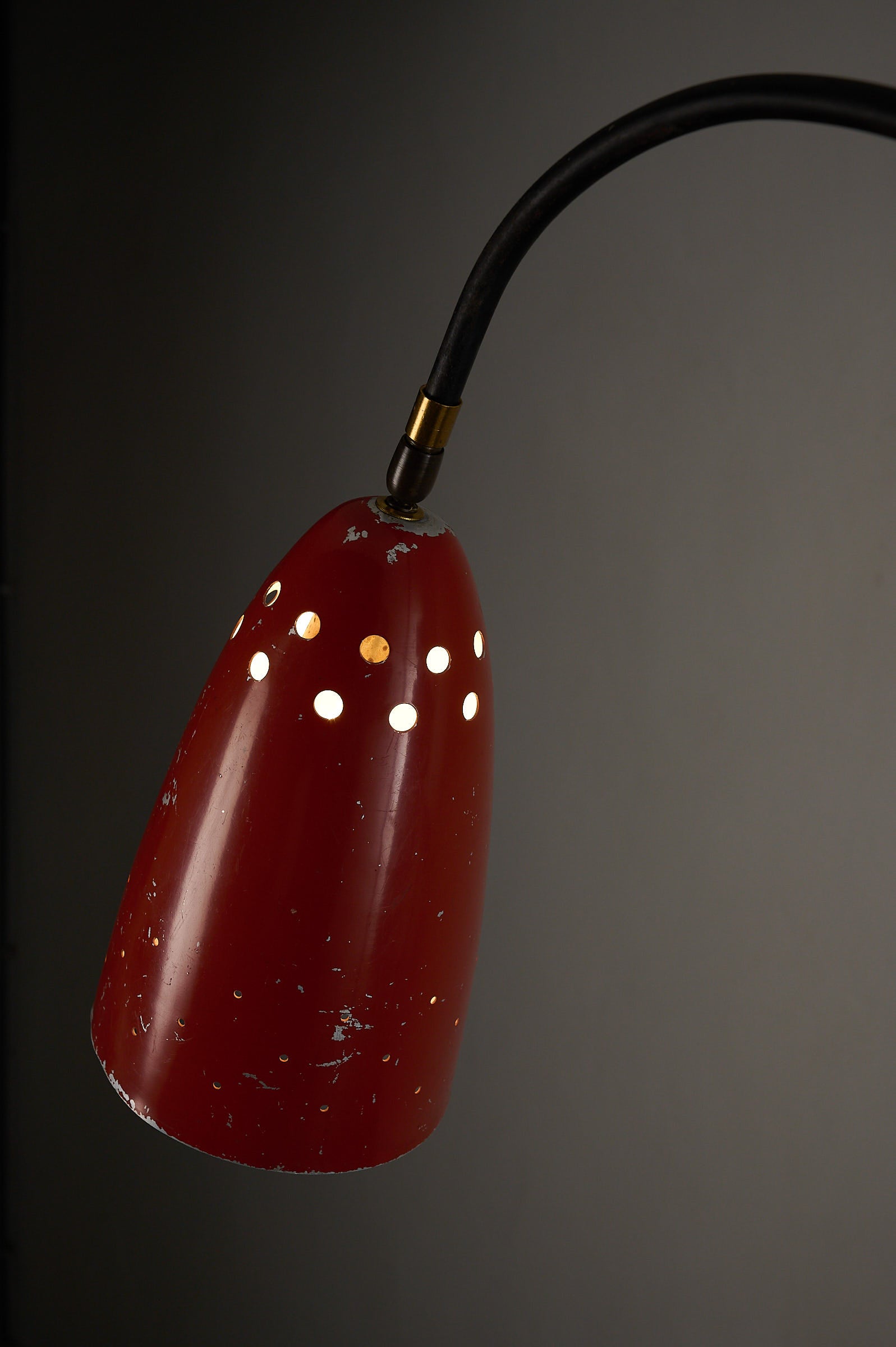 'Grasshopper' Floor Lamp, The Netherlands, 1950s showcasing the vibrant red aluminum shade with intricate perforations.