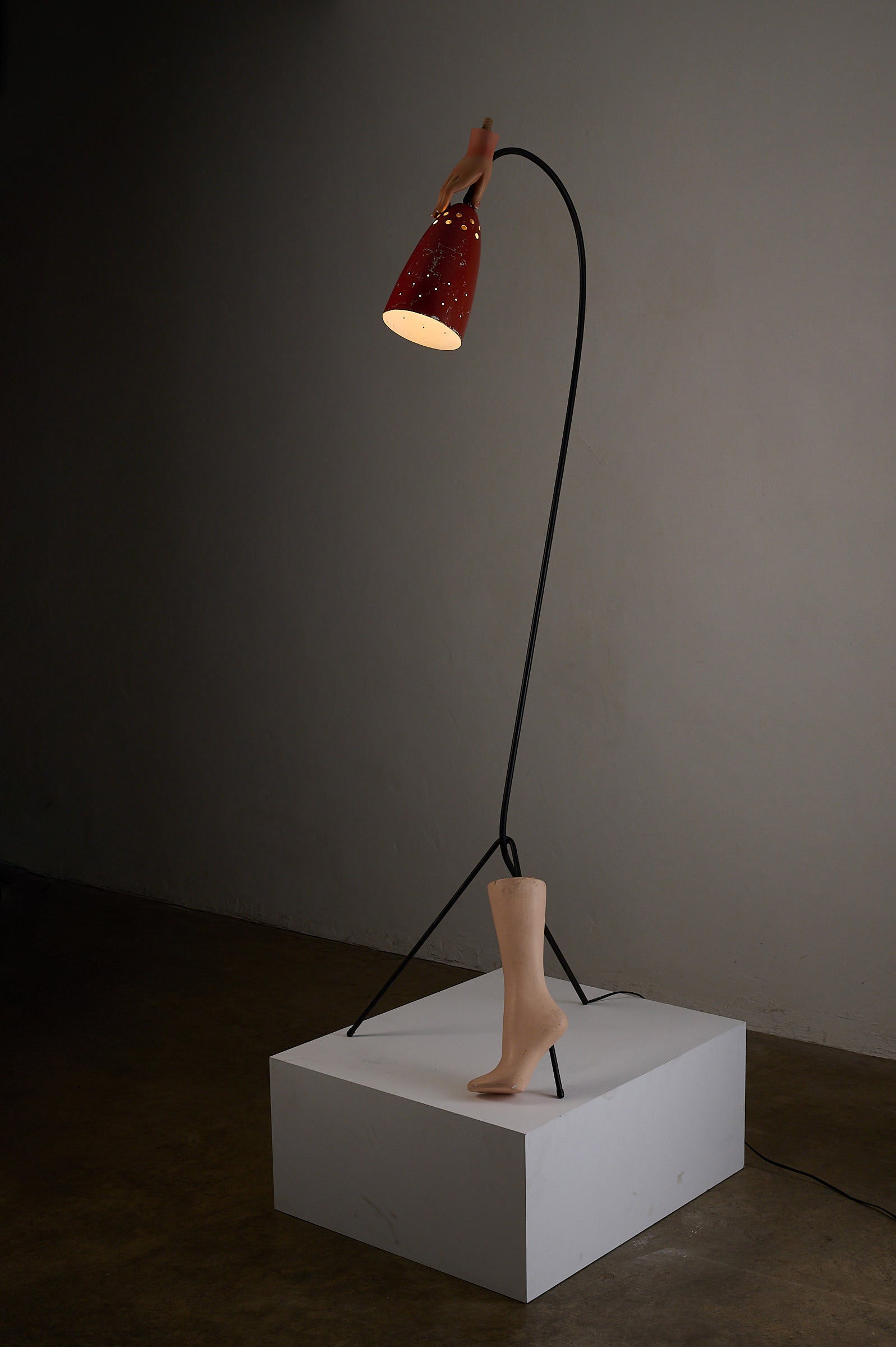 'Grasshopper' Floor Lamp, The Netherlands, 1950s with a red shade and minimalist black tripod base.