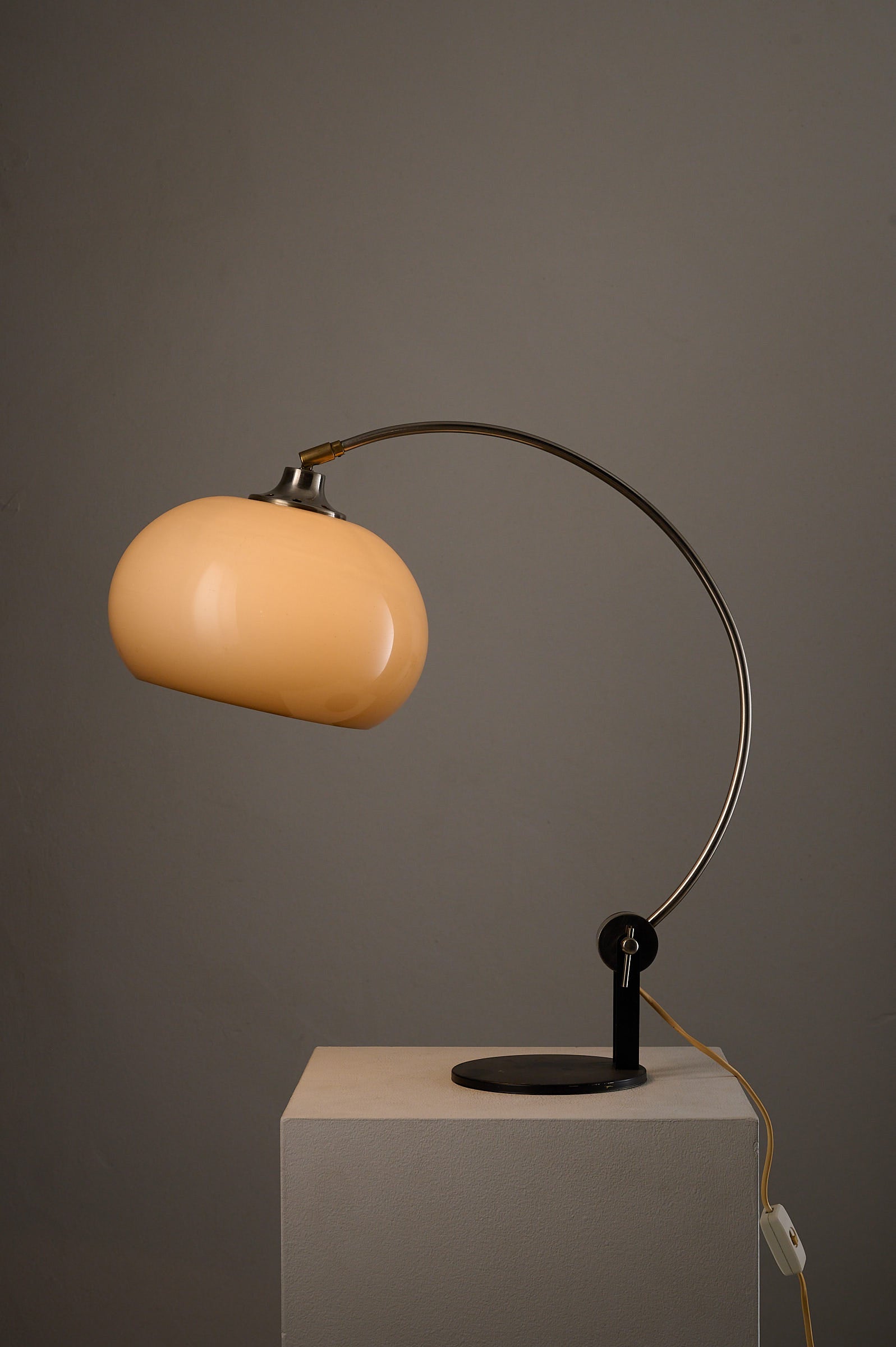 Chrome Arc Desk Lamp by Cosack Leuchten, Germany, 1970s on display with warm amber acrylic shade.