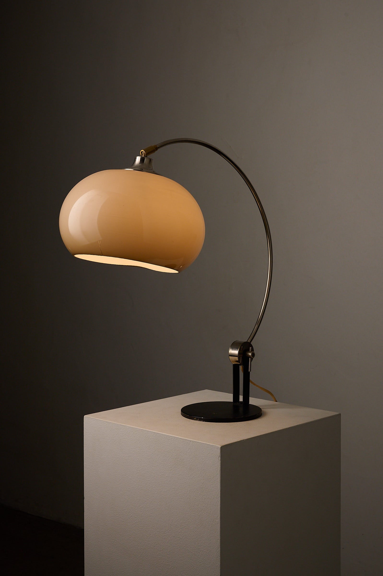 Chrome Arc Desk Lamp by Cosack Leuchten, Germany, 1970s on display with warm ambient light.