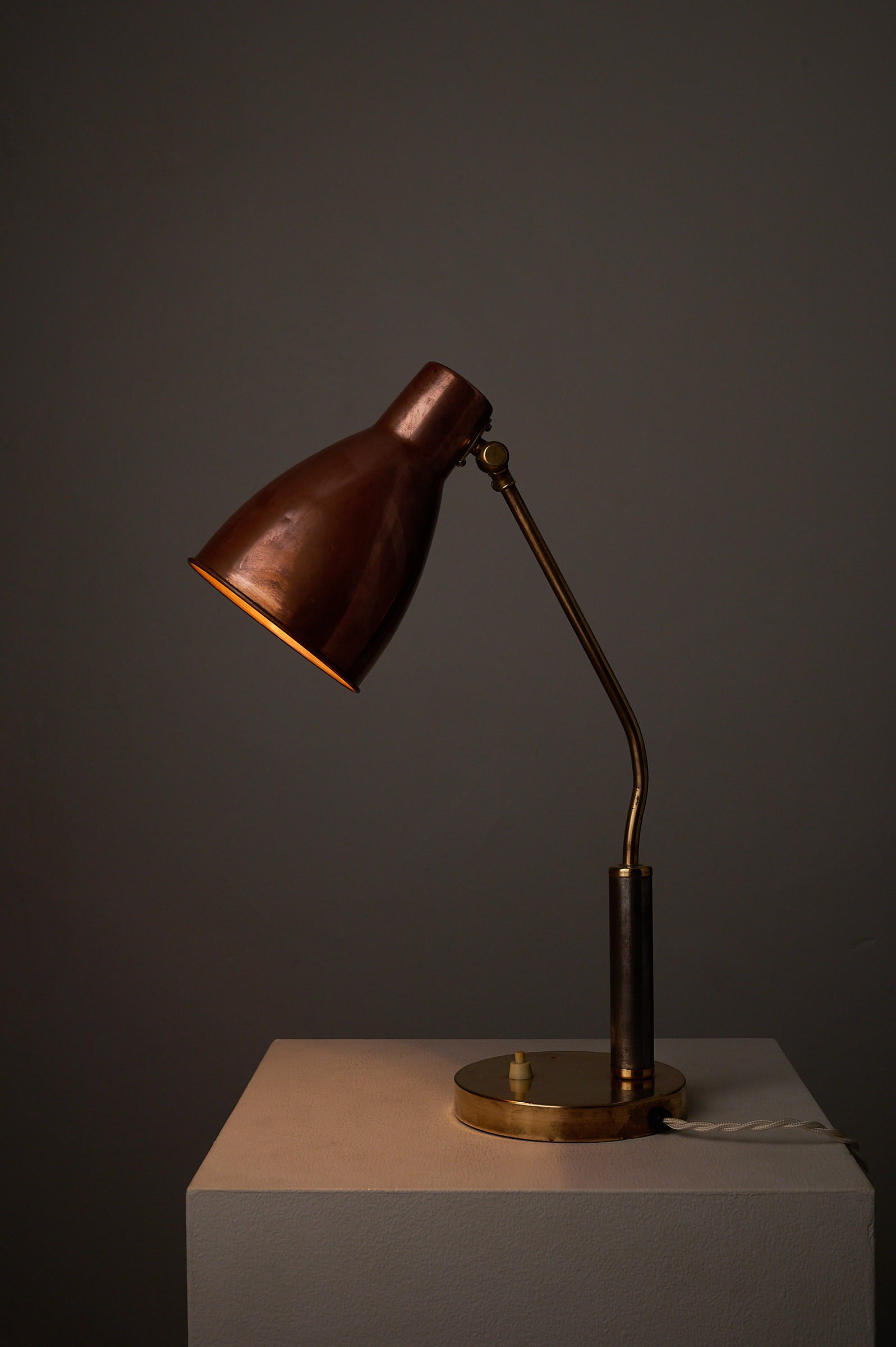 Mid-Century Modern Copper & Brass Desk Lamp, Europe, 1950s on a pedestal with warm lighting.