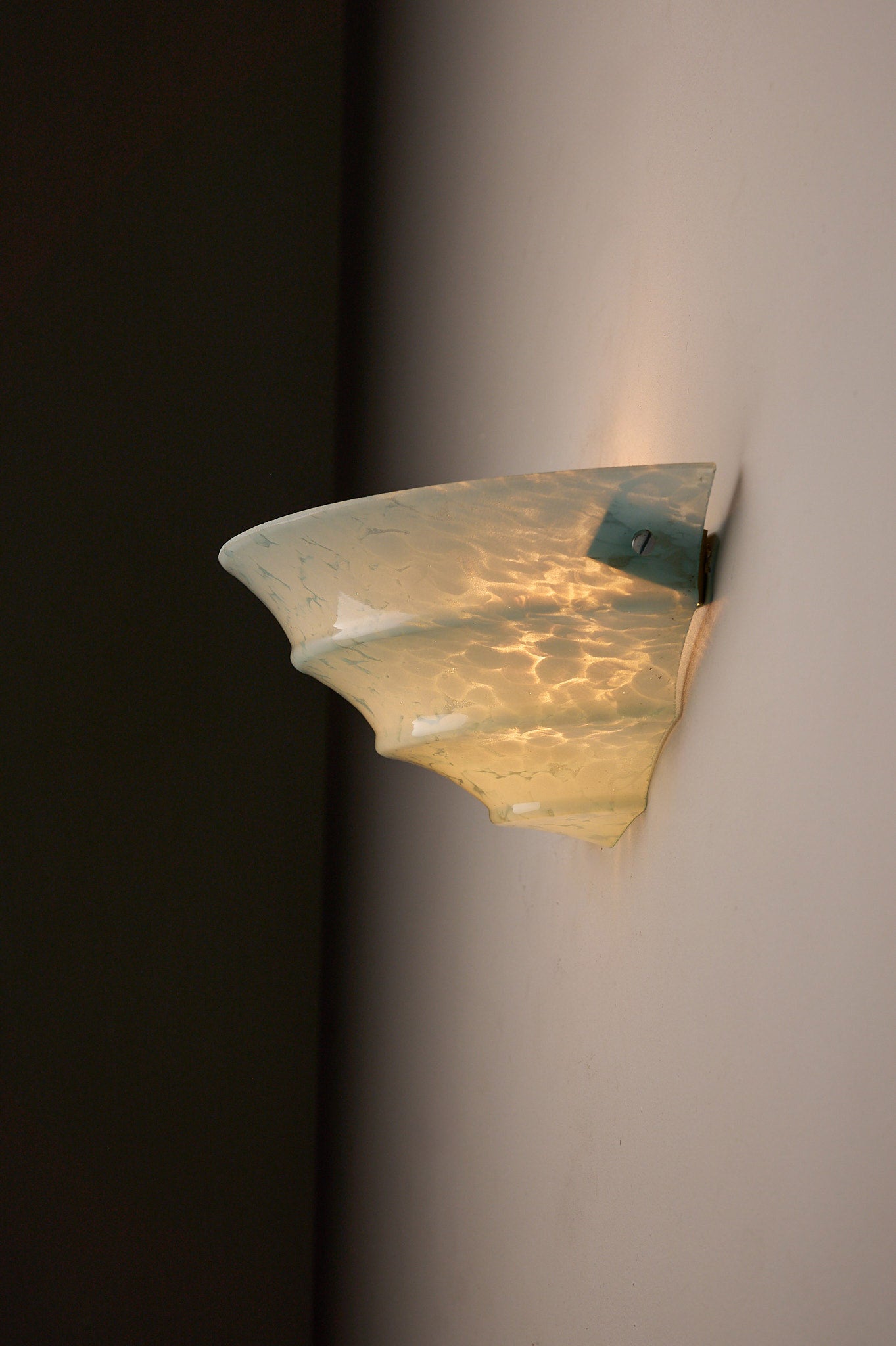 1940s Mid-Century Blue Marbled Glass Shell Wall Sconce illuminating a wall with a unique blue marbled texture.