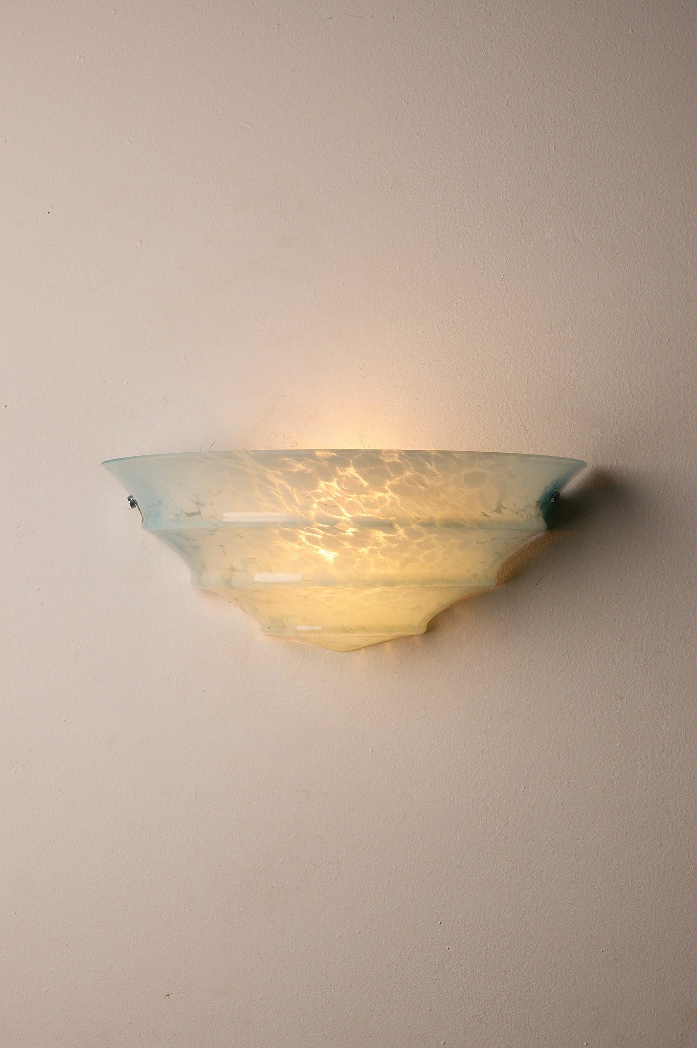 1940s Mid-Century Blue Marbled Glass Shell Wall Sconce illuminating a wall with a soft light.