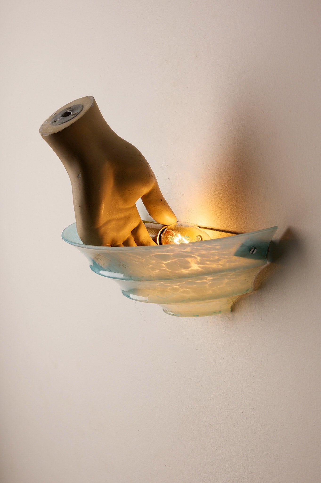 1940s Mid-Century Blue Marbled Glass Shell Wall Sconce with hand-shaped detail and glowing light.